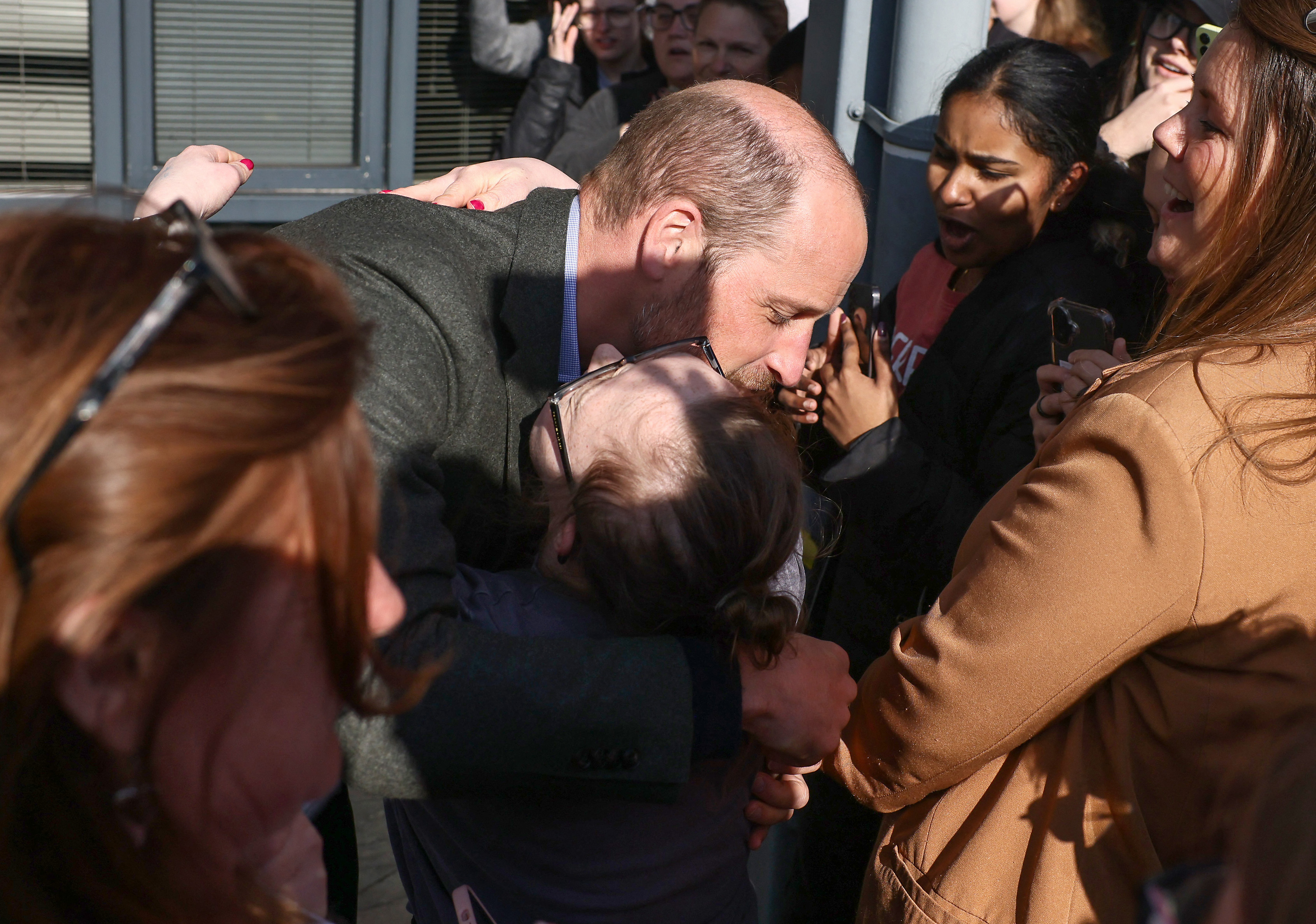 Prince William, Prince of Wales (L) embraces well-wisher Natasha Gorry during a visit to see how Homewards Bournemouth, Christchurch and Poole (BCP) has helped bring local organisations together to create successful employment programmes at Bournemouth and Poole College on 28 February 2025 in Poole, England. | Source: Getty Images