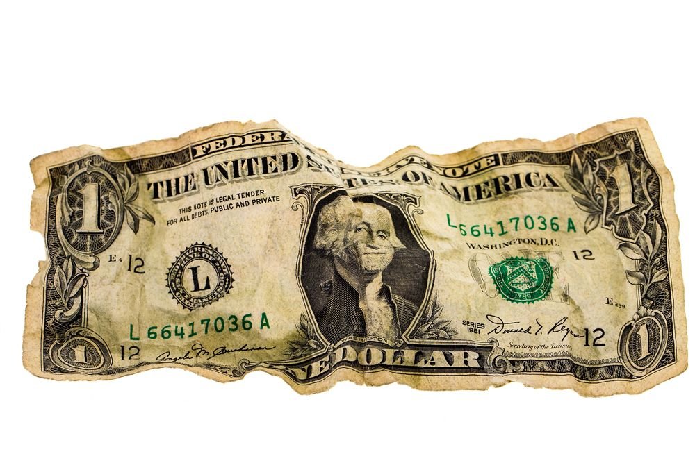 An crumpled up $1.00 bill. | Source: Shutterstock