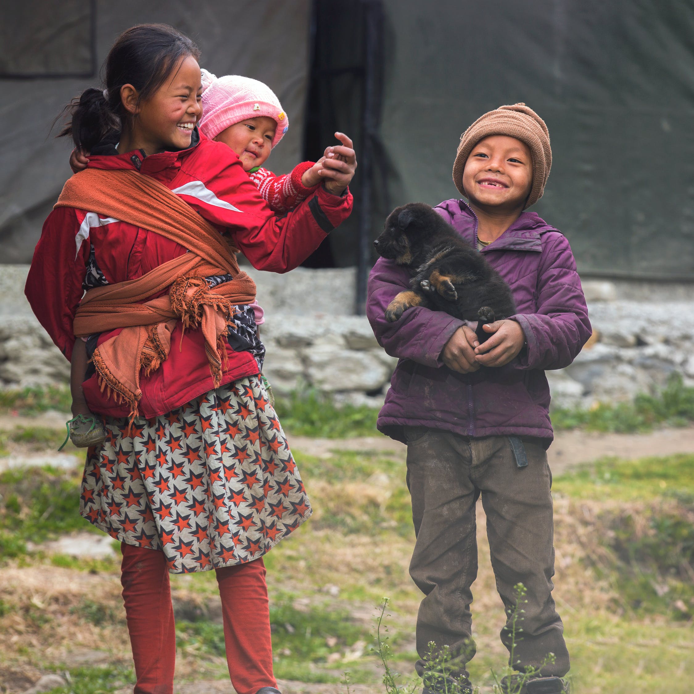 Three children smiling. | Photo: Pexels