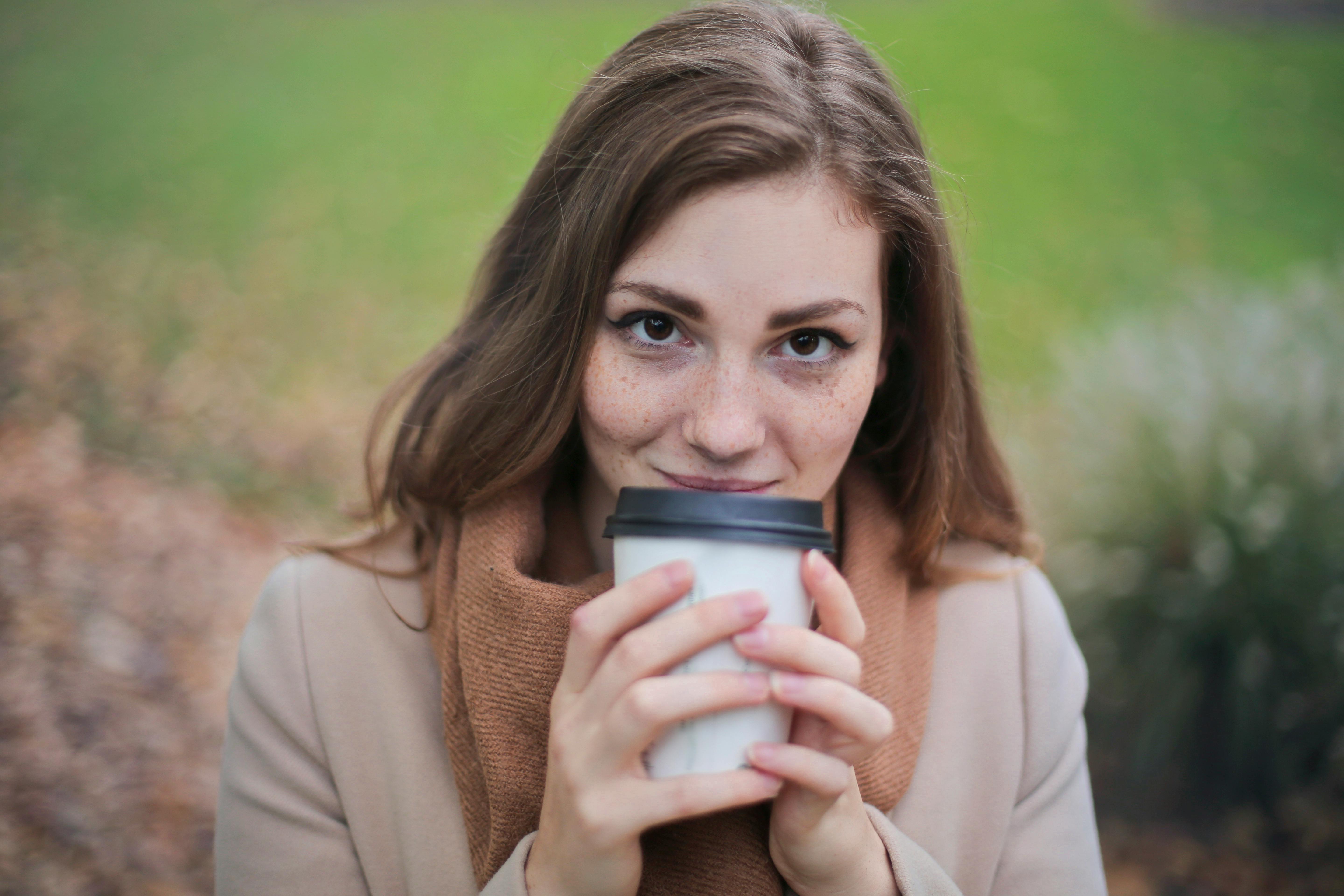 A happy woman drinking coffee | Source: Pexels