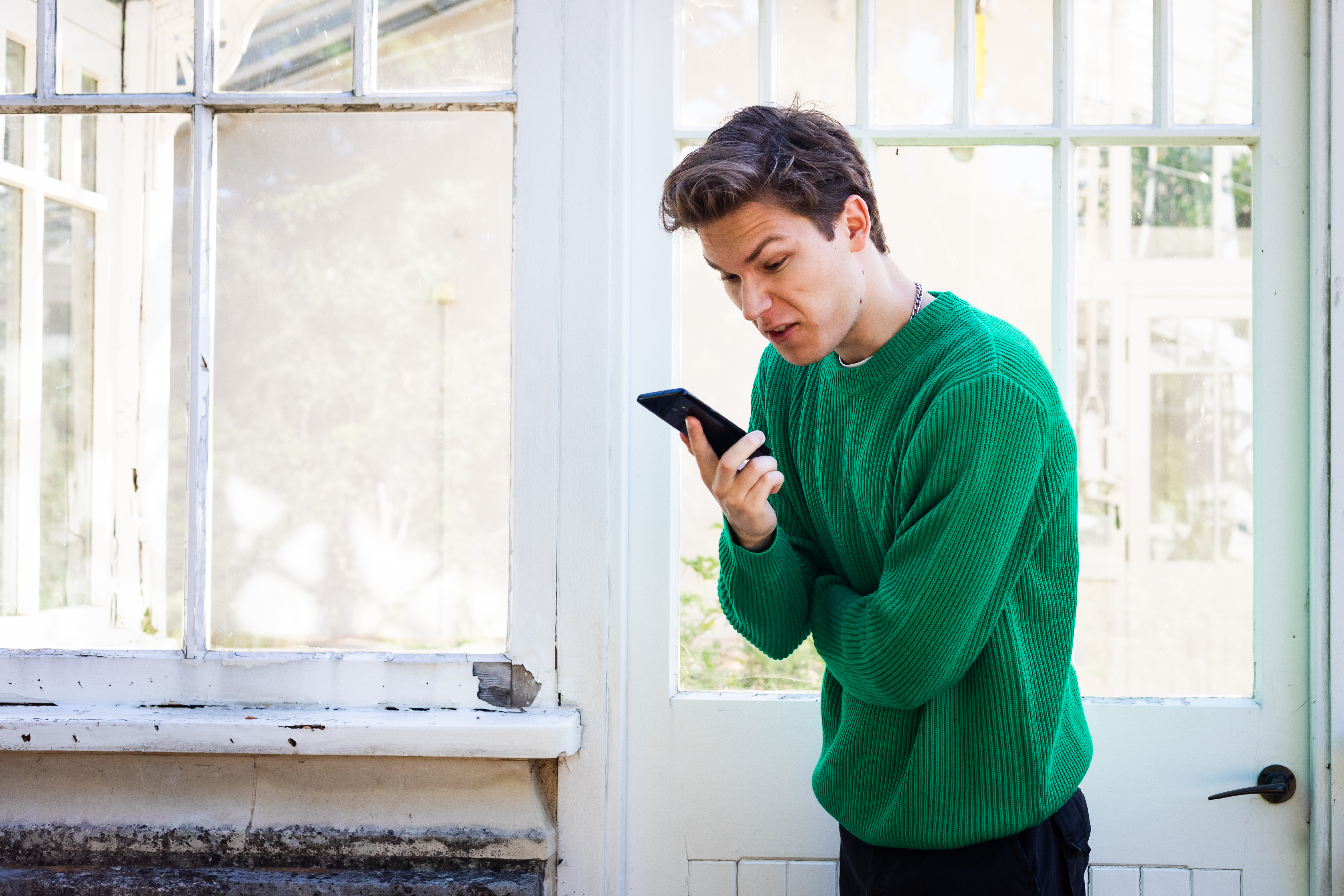 Angry man looking at phone | Source: Shutterstock