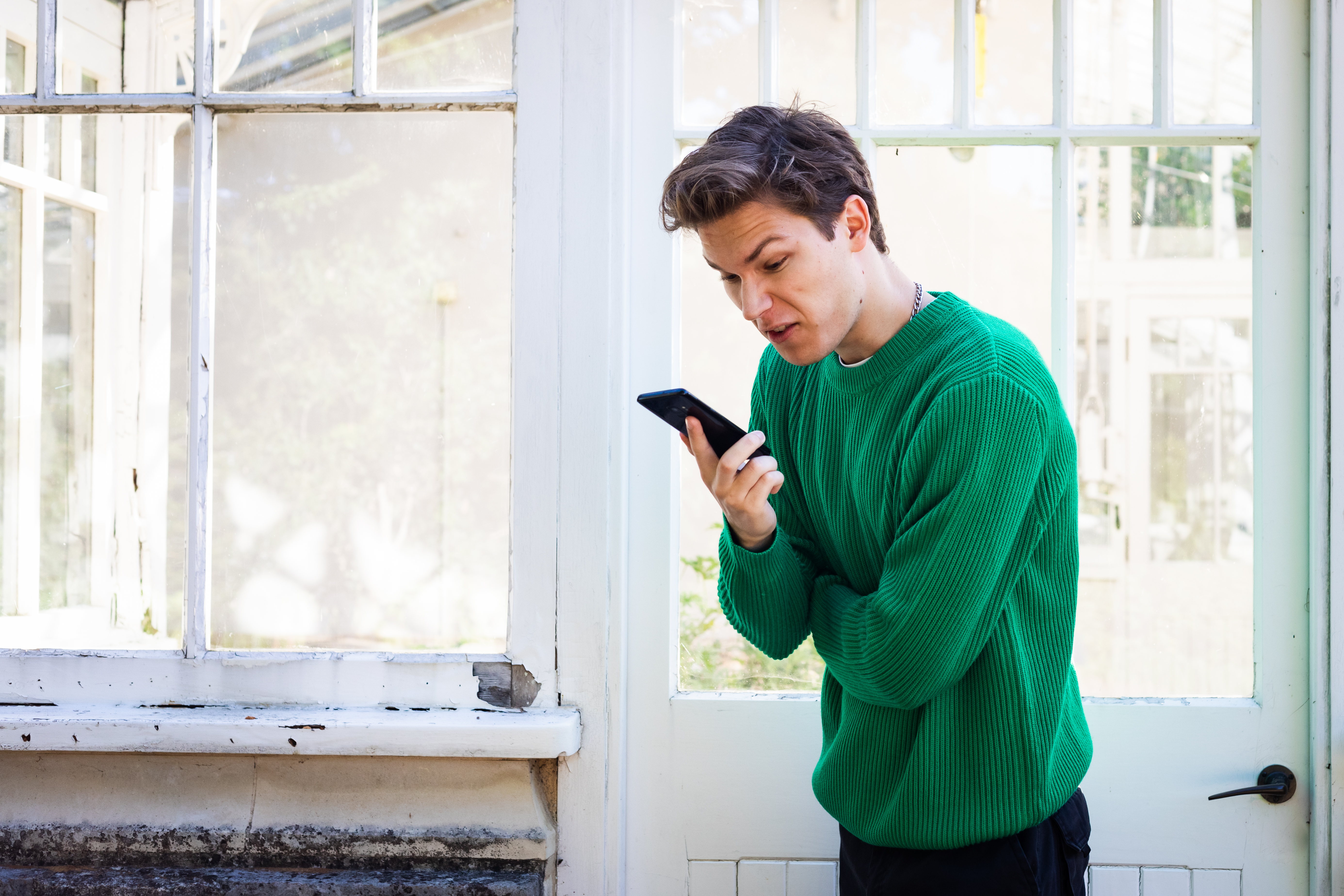 An angry man looking at a phone | Source: Shutterstock