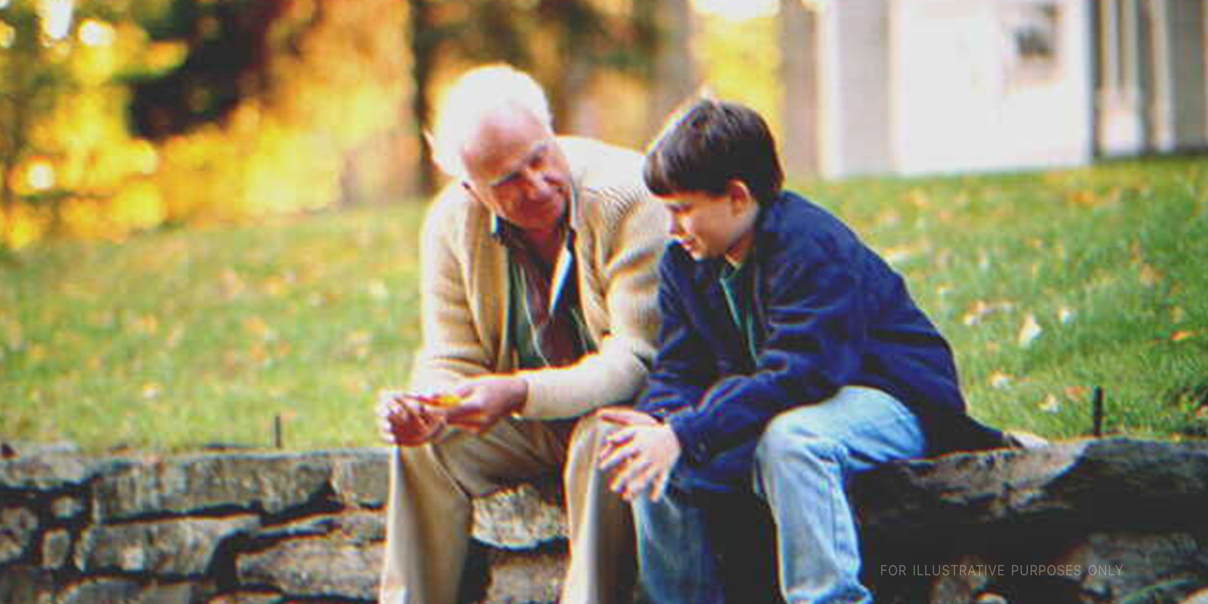 Elderly man and boy in a park | Getty Images