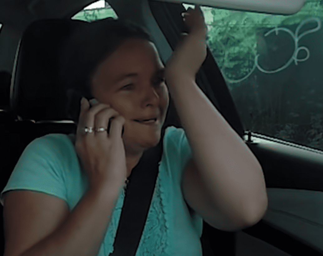 A grieving woman is overcome with emotion after receiving a big surprise. | Source: youtube.com/channel/Kyle and Jackie O