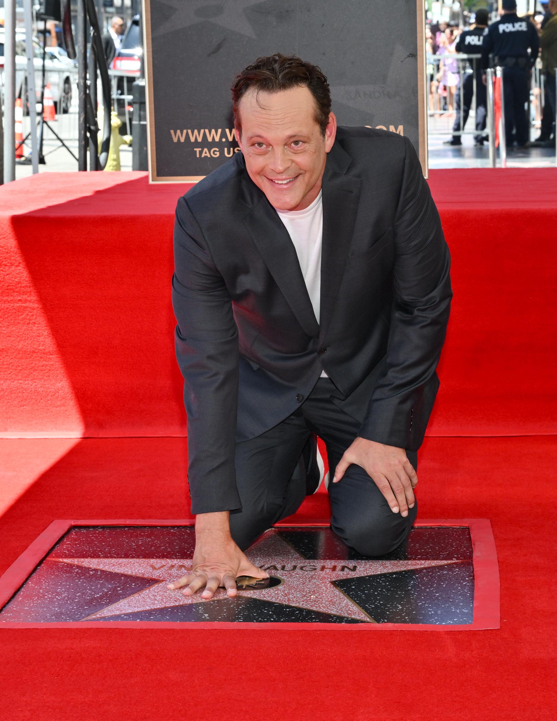 Vince Vaughn smiles as he touches his star during the Hollywood Walk of Fame ceremony on August 12, 2024 | Source: Getty Images