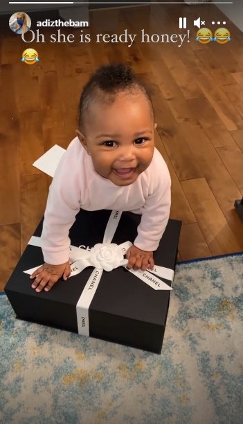 Lil Scrappy & Bambi Benson's daughter Xylo flashes a huge smile while playing with a Chanel box. | Source: Instagram.com/adizthebam