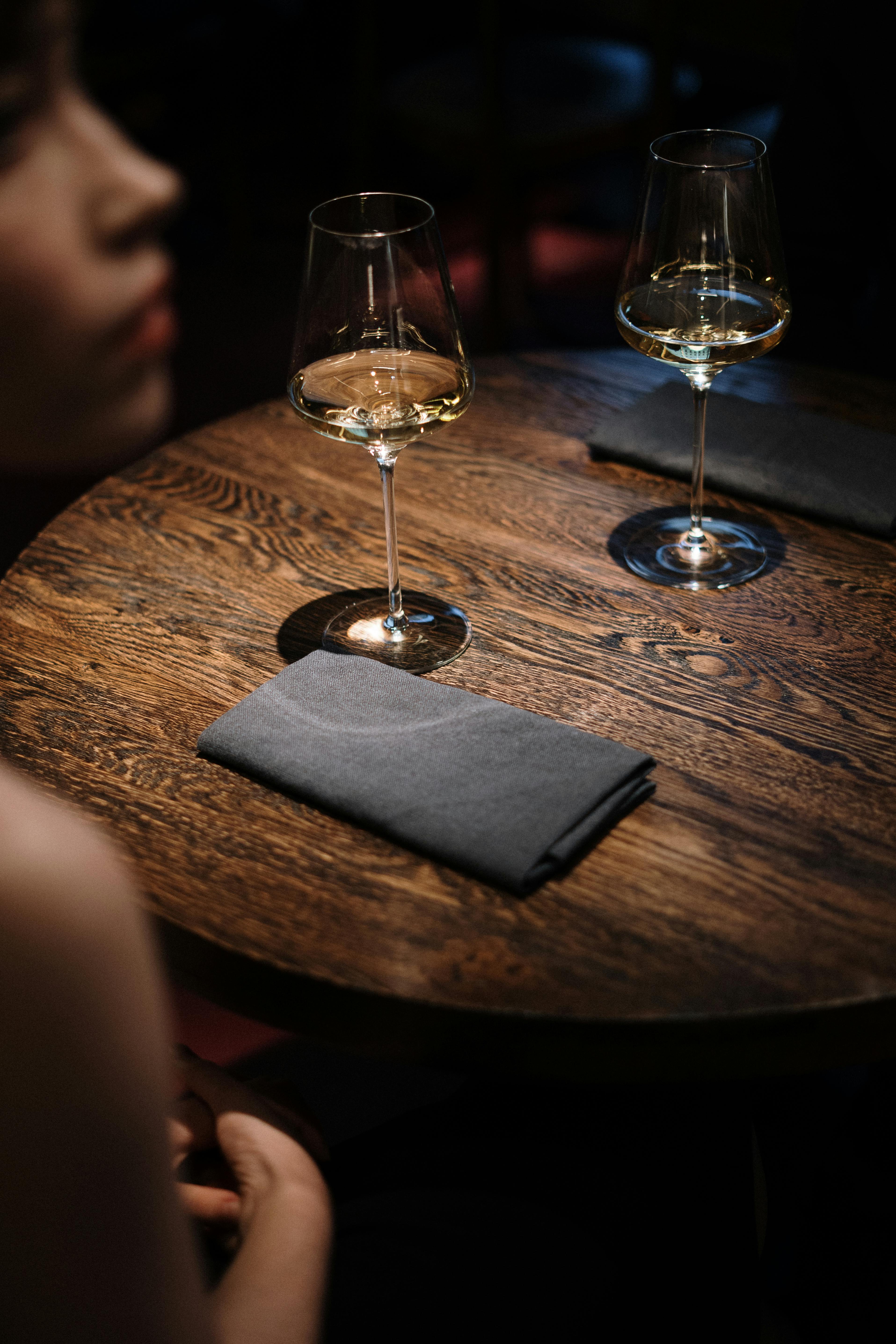 A woman sitting at a café table, looking up | Source: Pexels