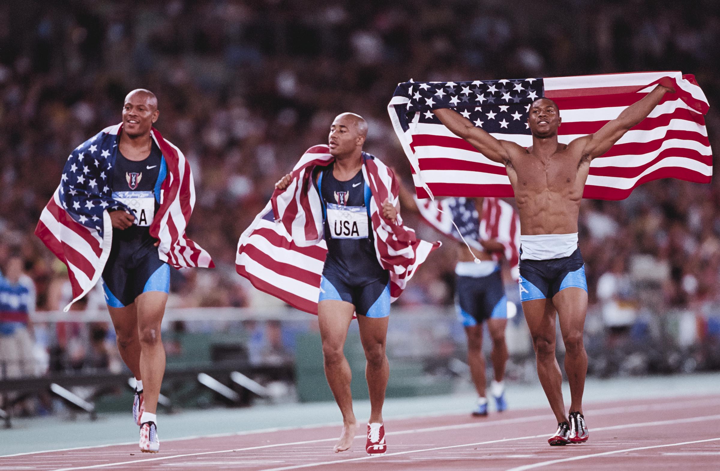 Maurice Green, Brian Lewis, and Bernard Williams III of Team United States celebrating winning the Men's 4x100-meter Relay during the 2000 Summer Olympics on September 30, in Sydney, Australia. | Source: Getty Images