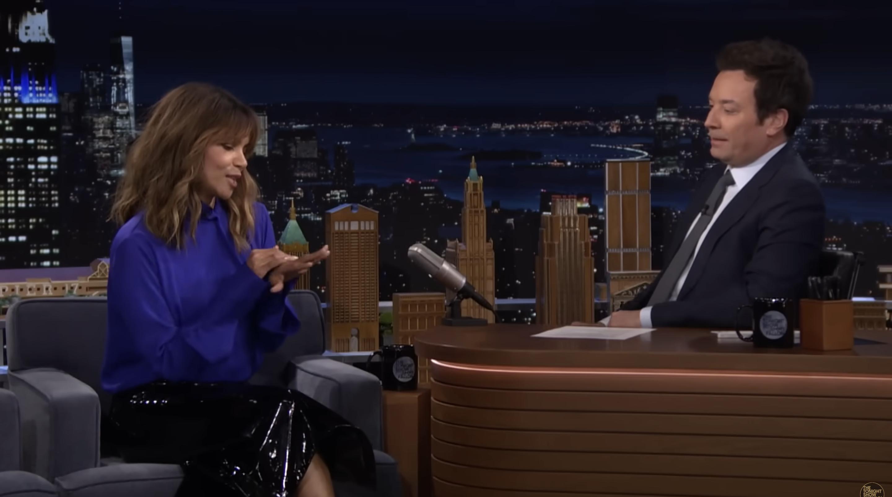 Halle Berry looks down at her hand while discussing her engagement with Jimmy Fallon | Source: YouTube/fallontonight