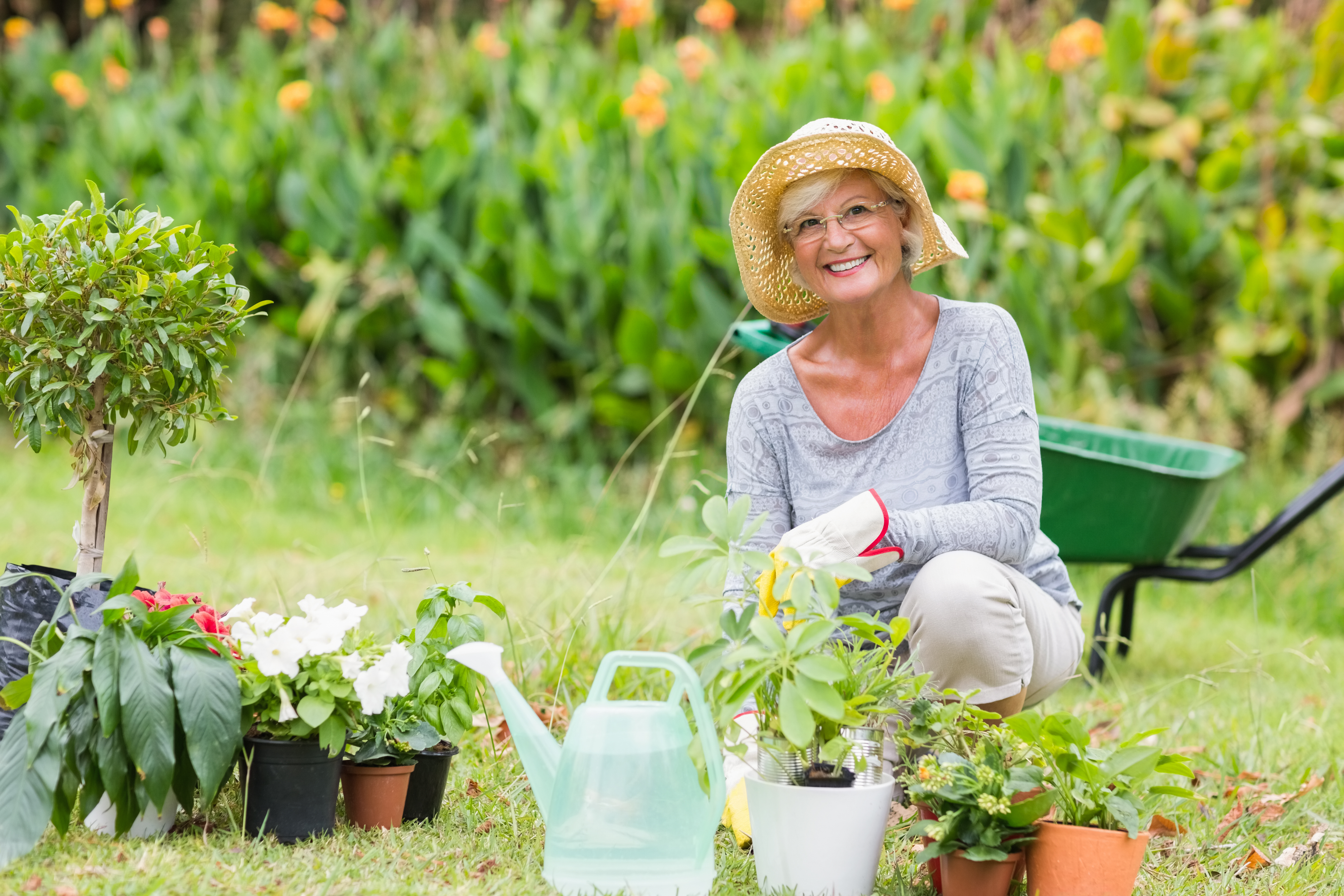 A happy senior lady working in her garden | Source: Shutterstock