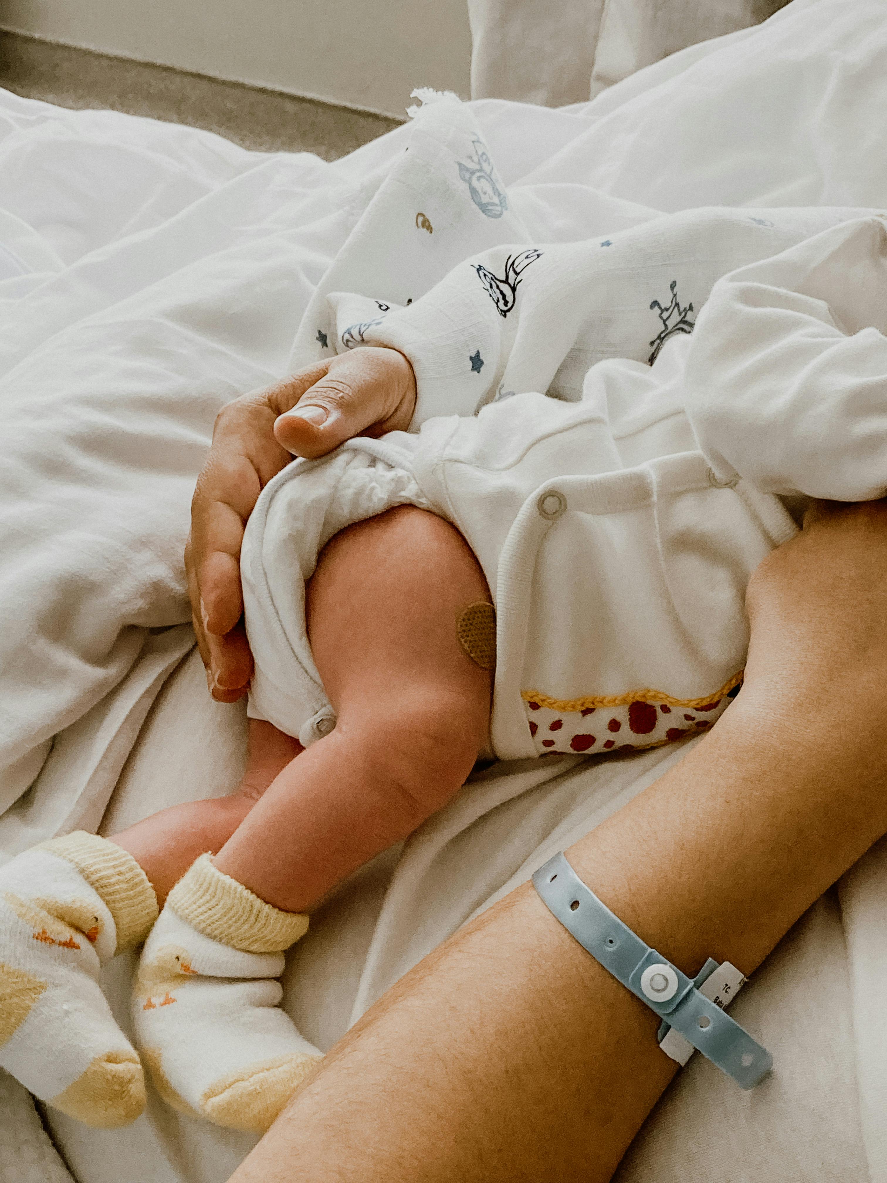 A mother holding a newborn baby | Source: Pexels