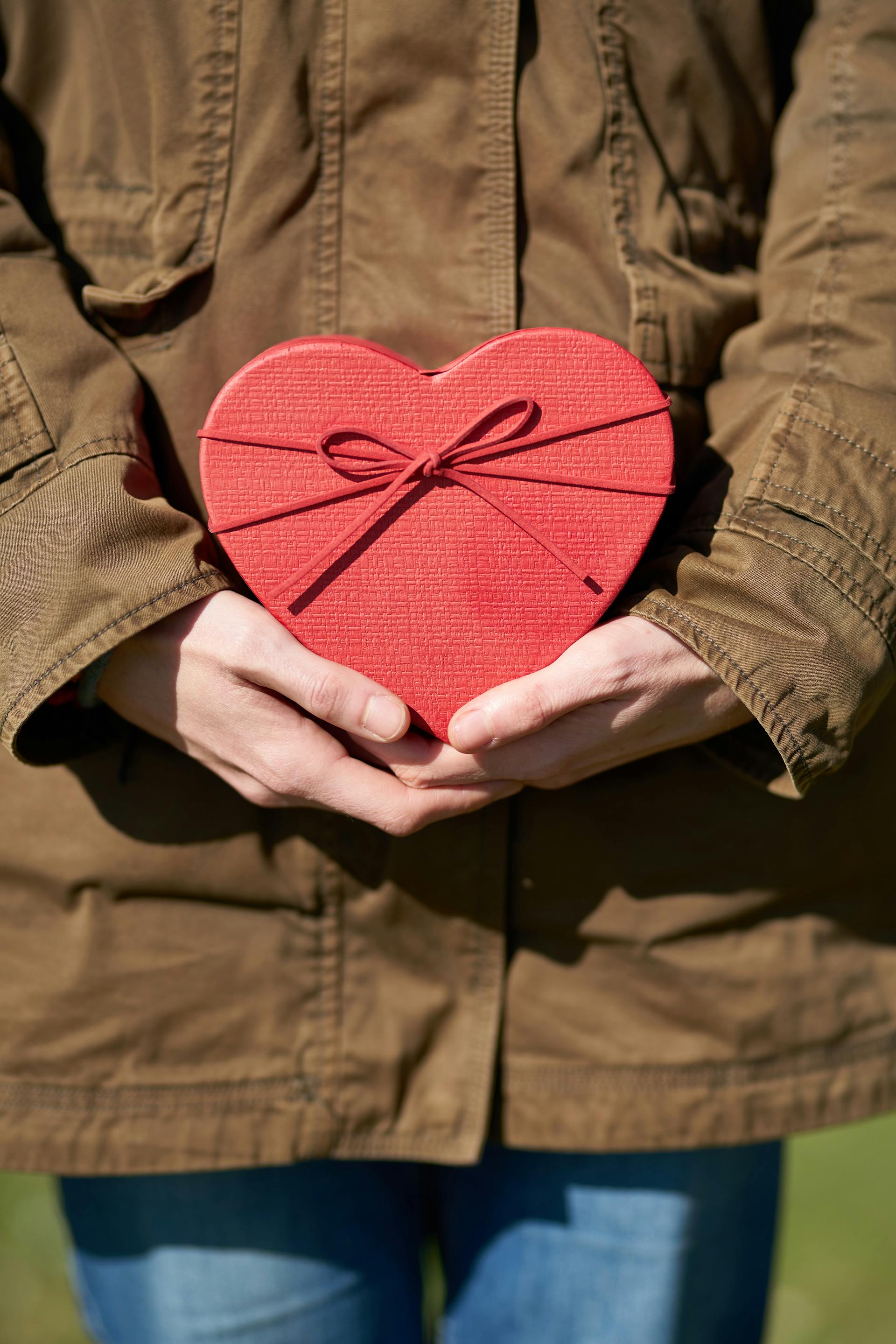 Person holding a heart-shaped gift | Source: Pexels