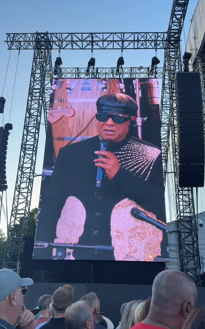 Stevie Wonder seen on a concert screen talking about the rumors about his eyesight during his tour stop at Cardiff, Wales on July 10, 2025 | Source: Instagram/cardifflife.wales