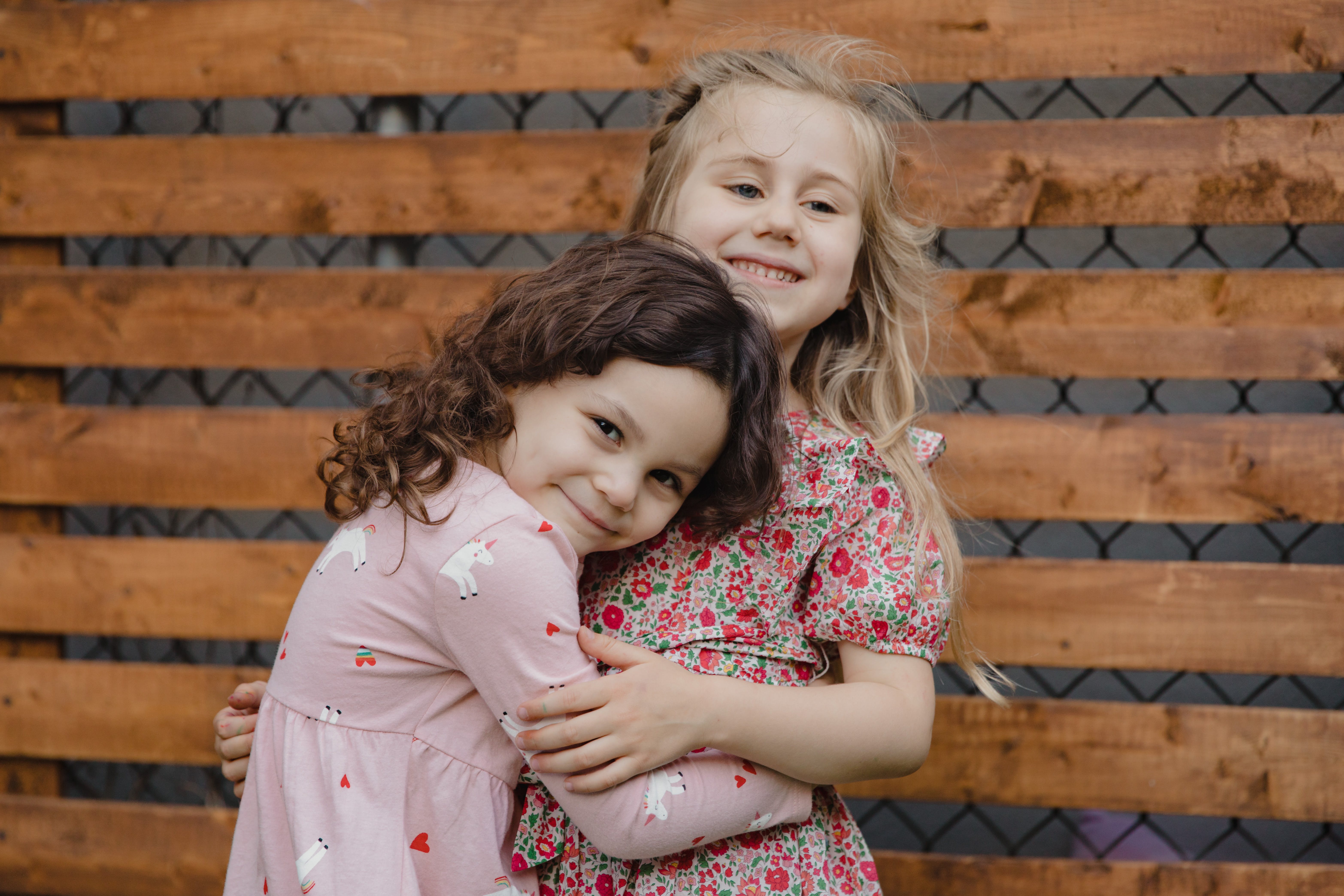 Two little girls sharing a hug | Source: Pexels