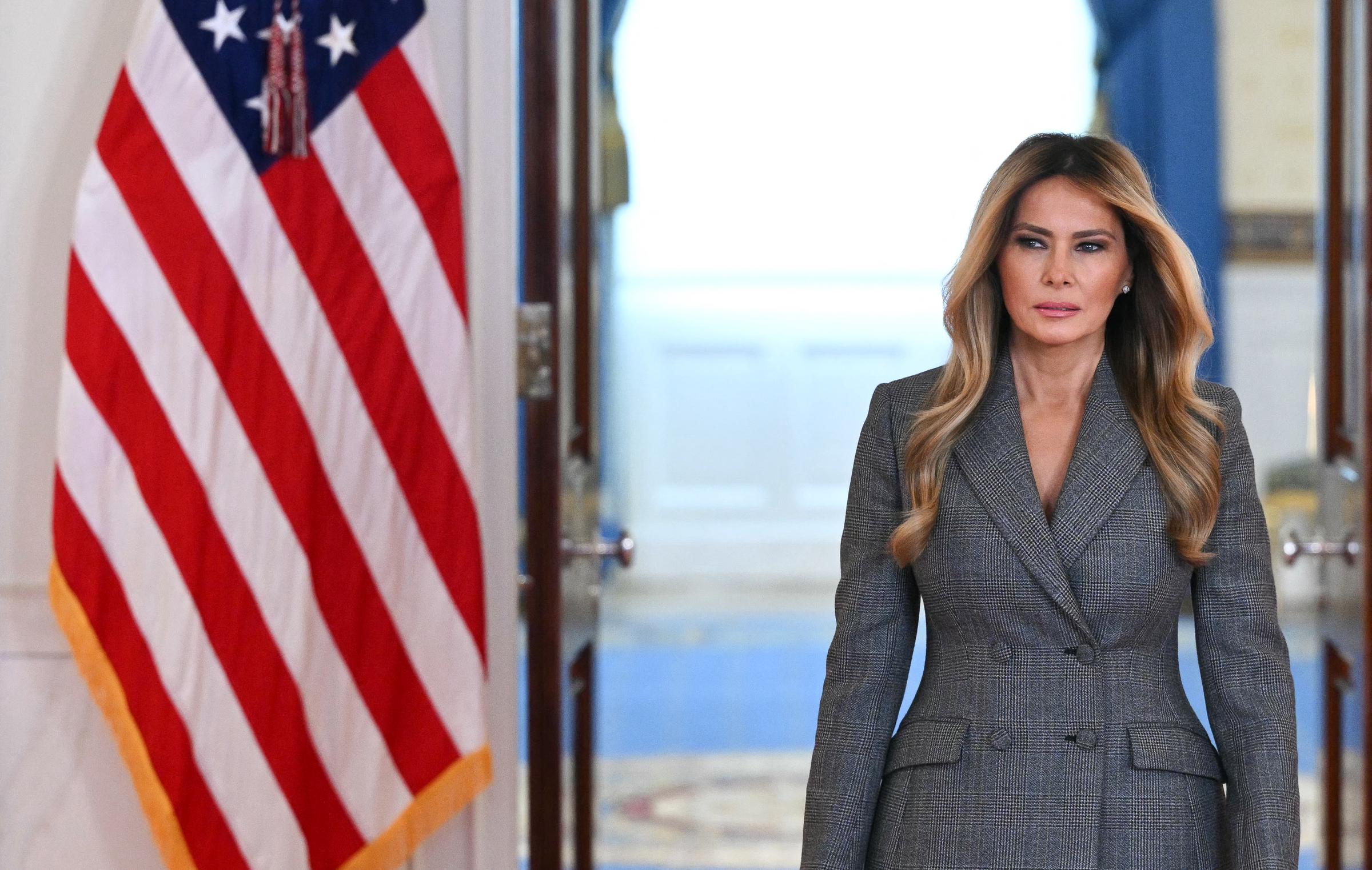 Melania Trump walks through the White House Cross Hall ahead of delivering ahead of her public statement | Source: Getty Images