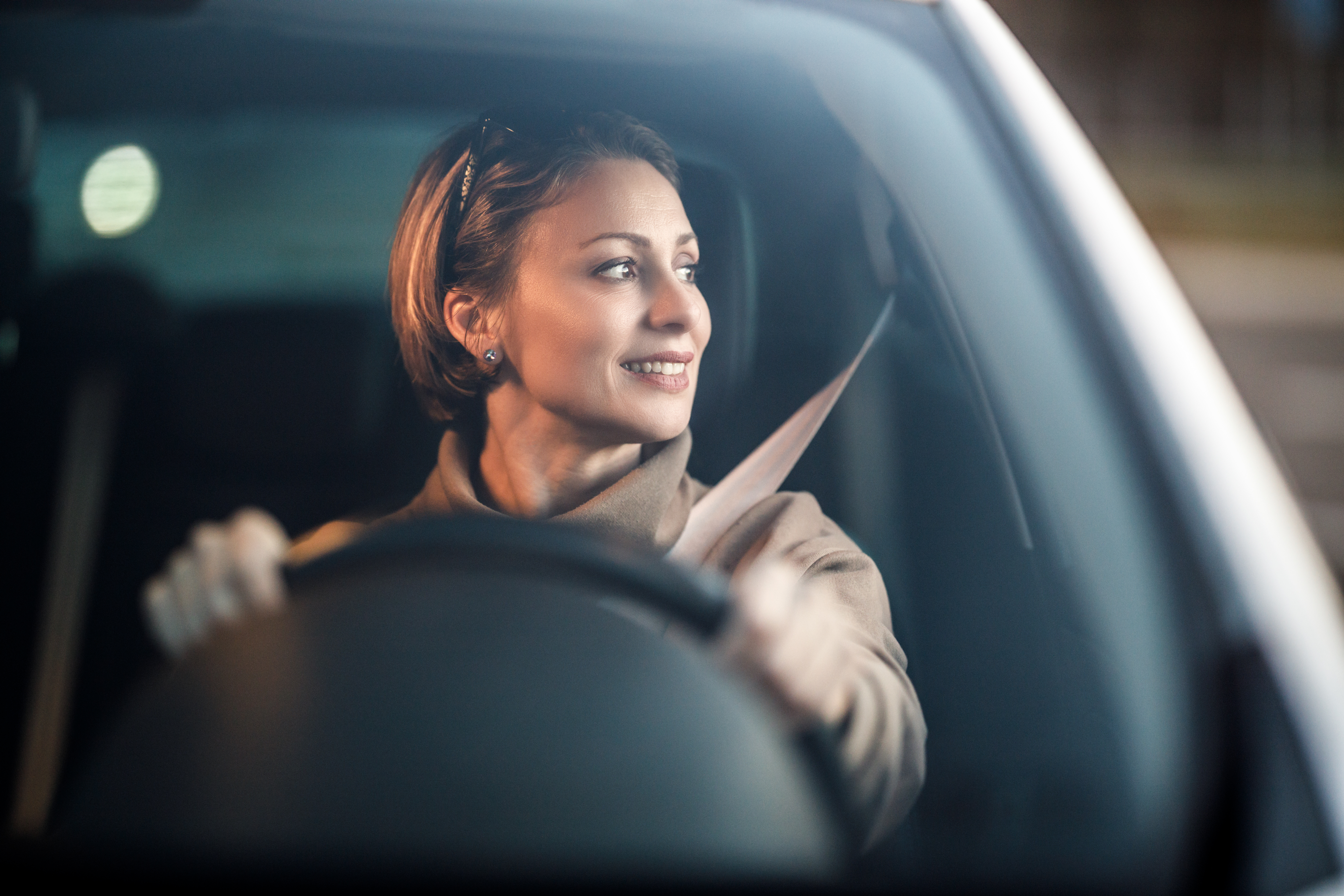 Shot of an attractive mature woman driving her car. | Source: Shutterstock
