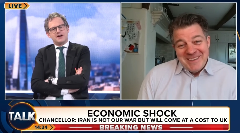 Liam Halligan was seen smiling during his "Talk TV" appearance in a video dated 14 April 2026, maintaining a composed yet relaxed demeanour as his personal life was brought into the spotlight during a discussion on global economic uncertainty. | Source: YouTube/TalkTV