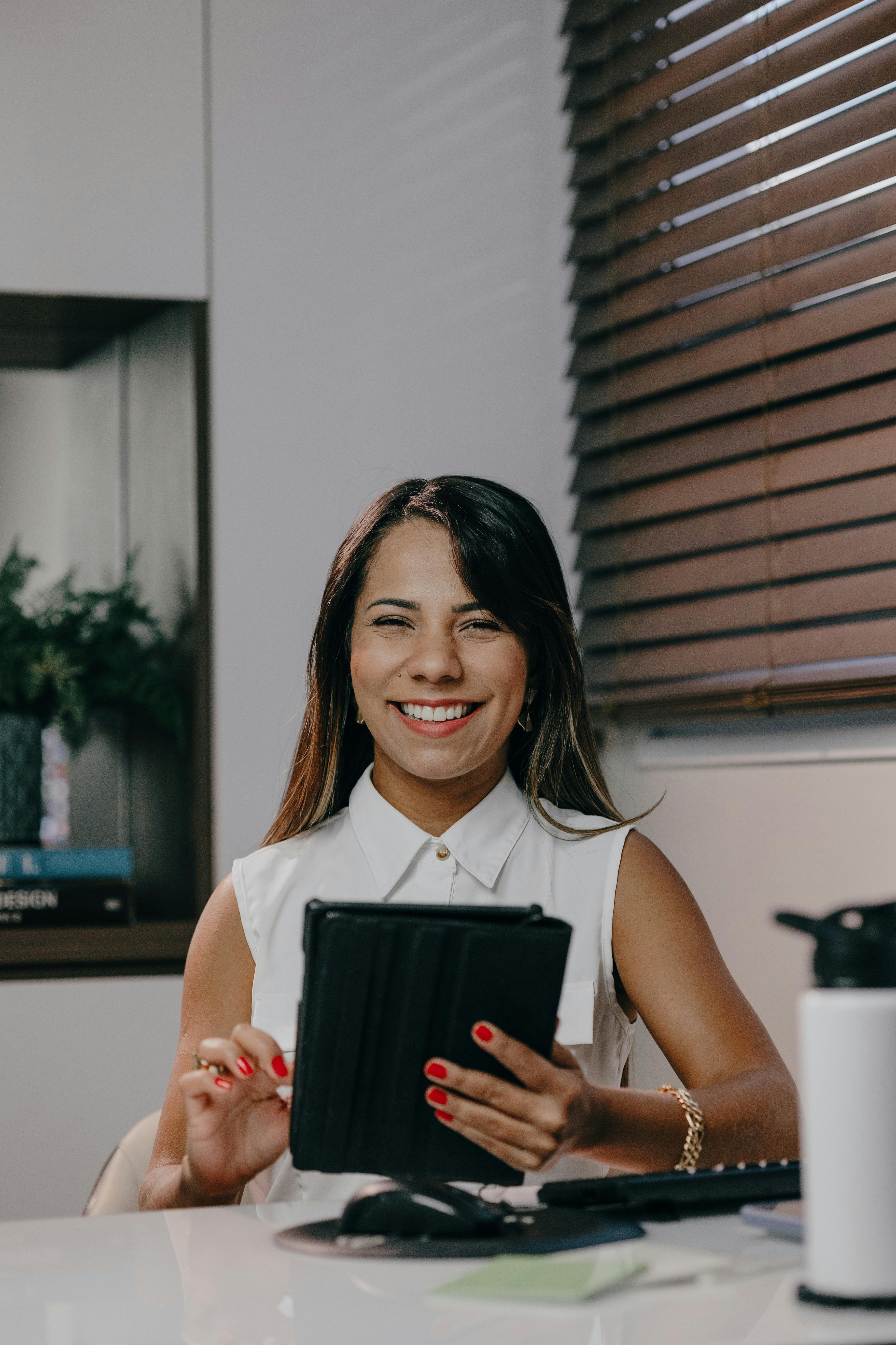 A smiling woman at her workplace | Source: Pexels