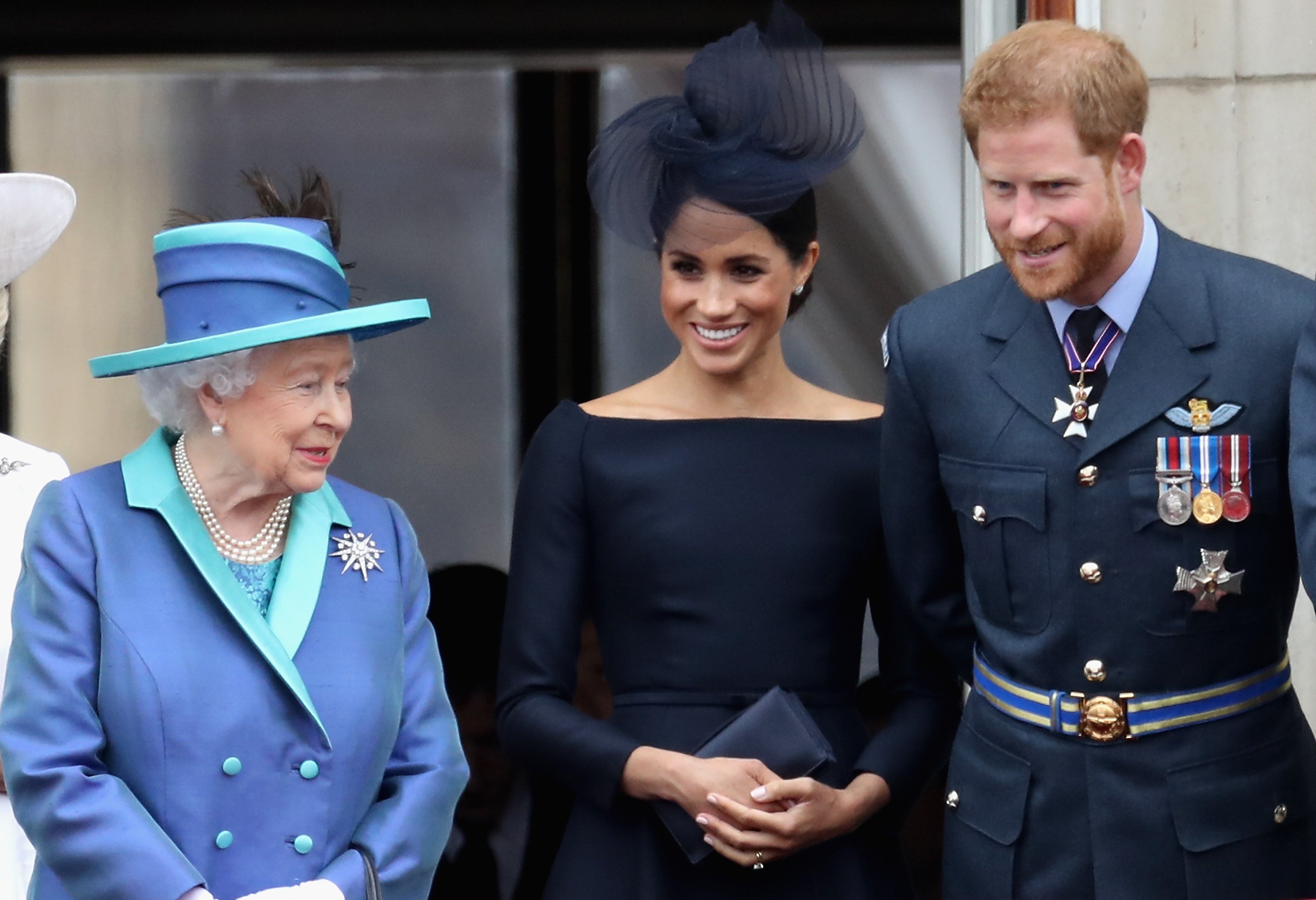 Queen Elizabeth II with Meghan Markle and Prince Harry watching the RAF flypast on the balcony of Buckingham Palace on July 10, 2018 in London, England. / Source: Getty Images
