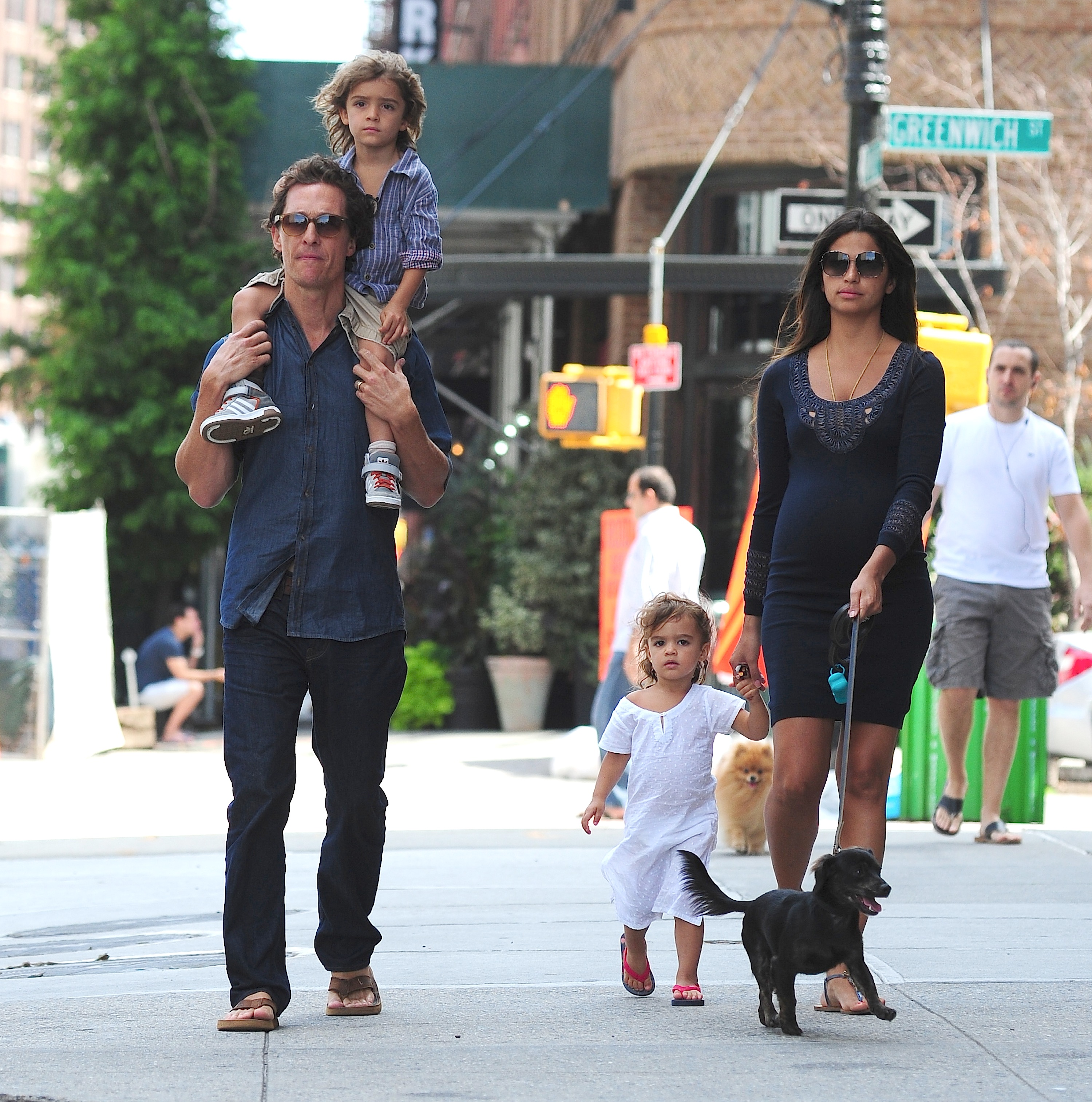 Dressed to impress — A smartly suited-up Levi walks hand-in-hand with dad Matthew McConaughey in Santa Monica on June 5, 2011, as mom Camila trails behind with little Vida in her arms.
