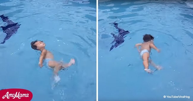 1-year-old girl swims in a pool all by herself