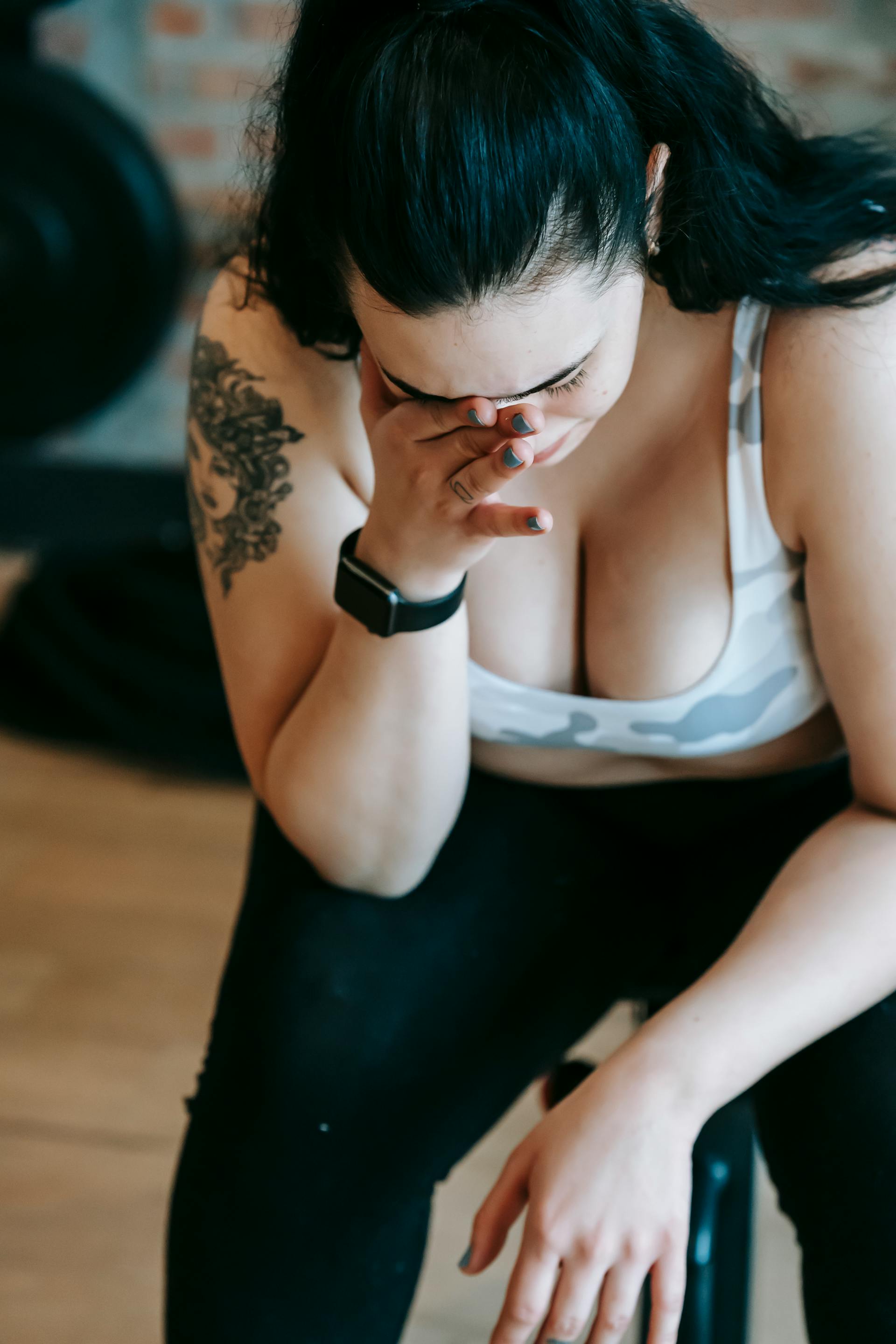 An upset plus-size woman with a hand on her face | Source: Pexels