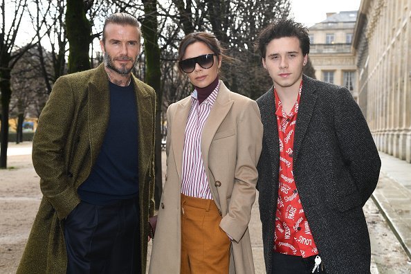 David Beckham, Victoria Beckham and Brooklyn Beckham attend the Louis Vuitton Menswear Fall/Winter 2018-2019 show as part of Paris Fashion Week on January 18, 2018, in Paris, France. | Source: Getty Images.