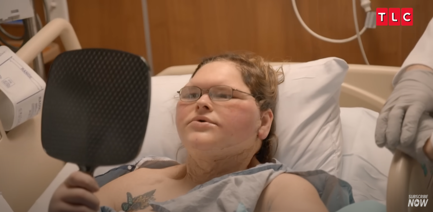 Tammy lifts the mirror, her expression shifting from shock to awe, from a video posted on June 11, 2025 | Source: YouTube/AccessHollywood