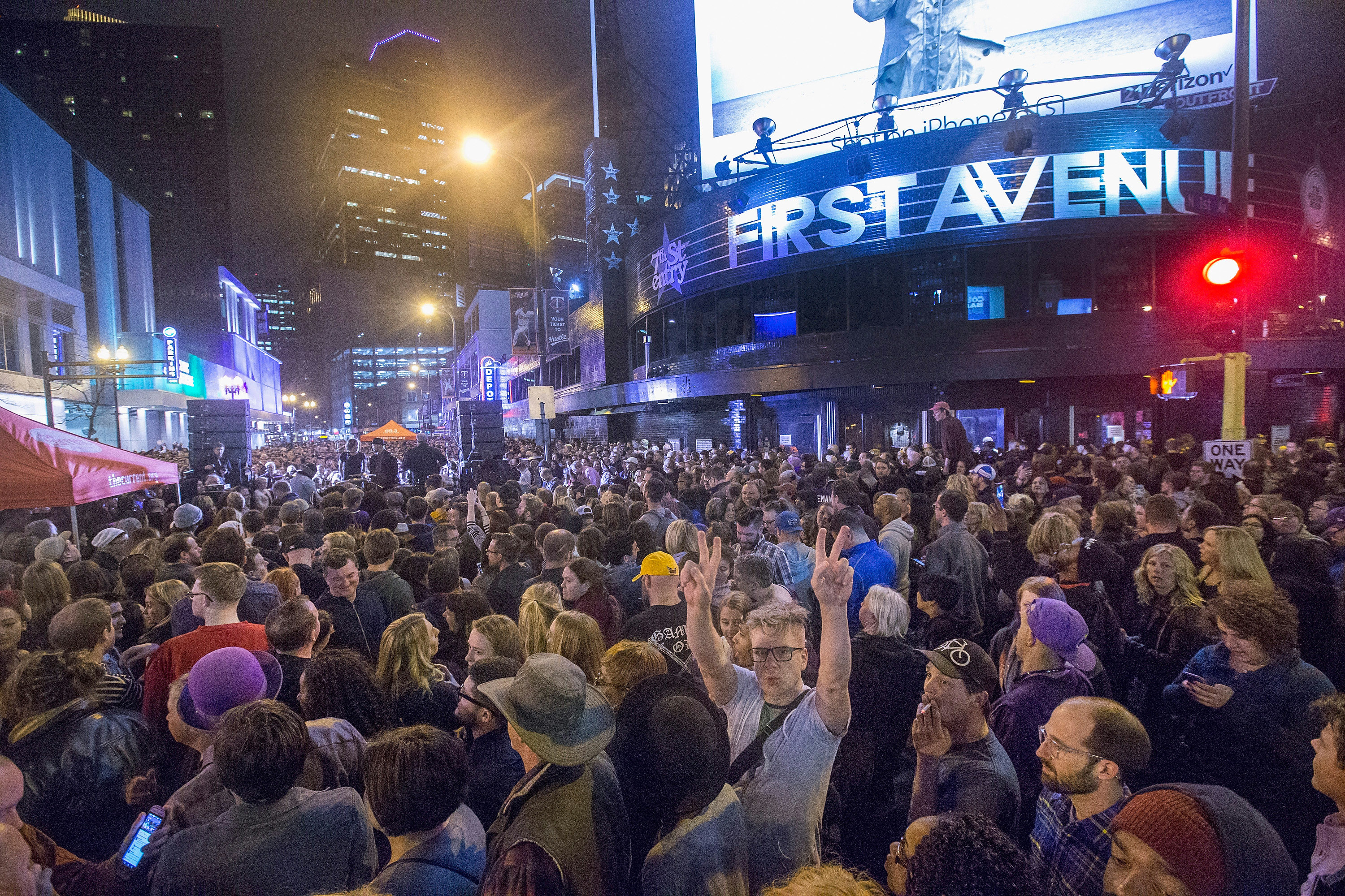 Fans listen to Prince music during a memorial street party outside the First Avenue nightclub in Minneapolis, Minnesota, on April 21, 2016 | Source: Getty Images