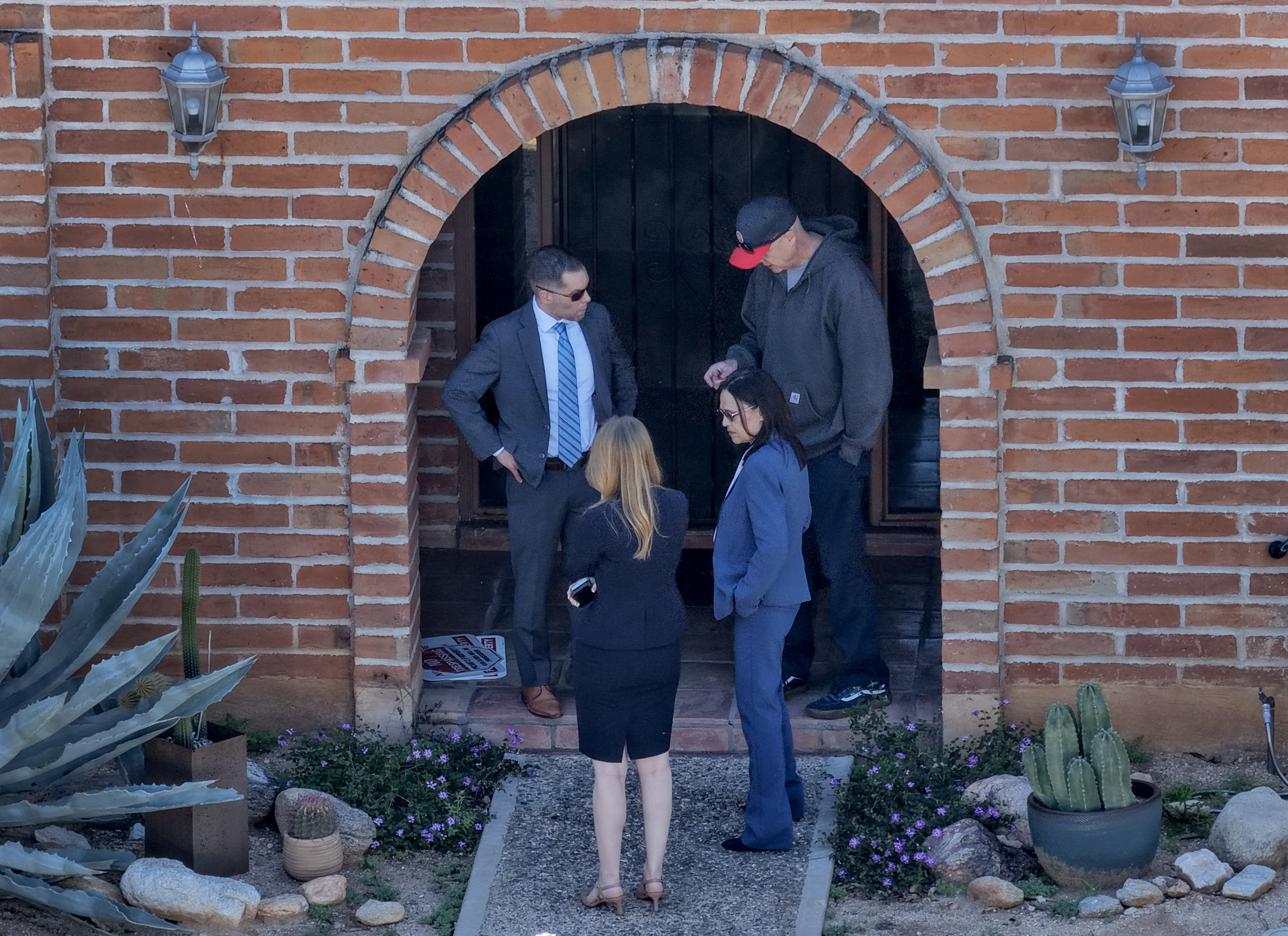 Law enforcement officials gather at the entrance of Nancy Guthrie's home during the investigation in Tucson, Arizona, on February 25, 2026 | Source: Getty Images