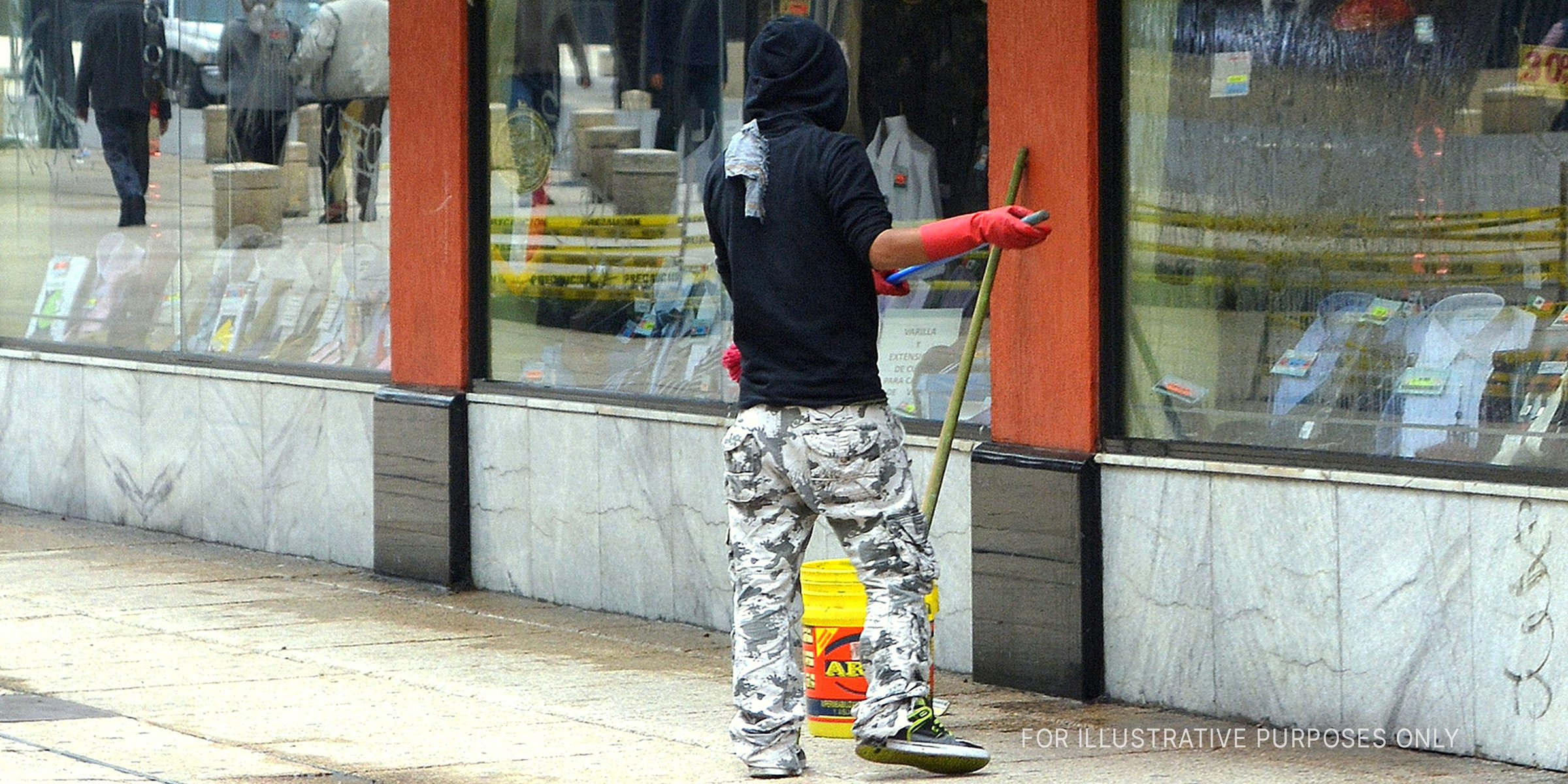 Man Sweeping The Pavement Outside A Store. | Source: Flickr / Carl Campbell (CC BY-SA 2.0)