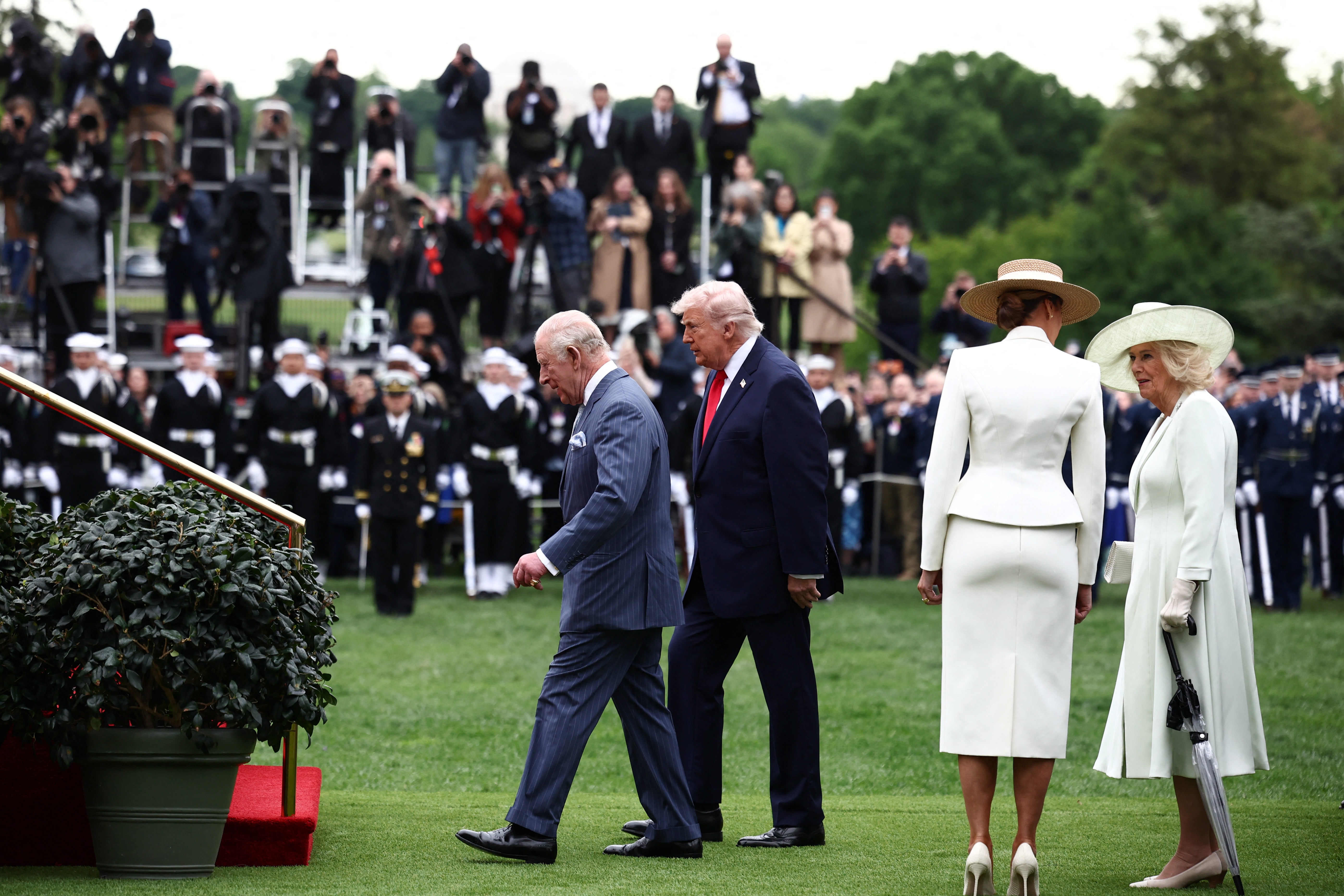 Donald Trump and King Charles III walk toward the stairs as Melania Trump and Queen Camilla follow during an arrival ceremony on the White House South Lawn, April 28, 2026. | Source: Getty Images