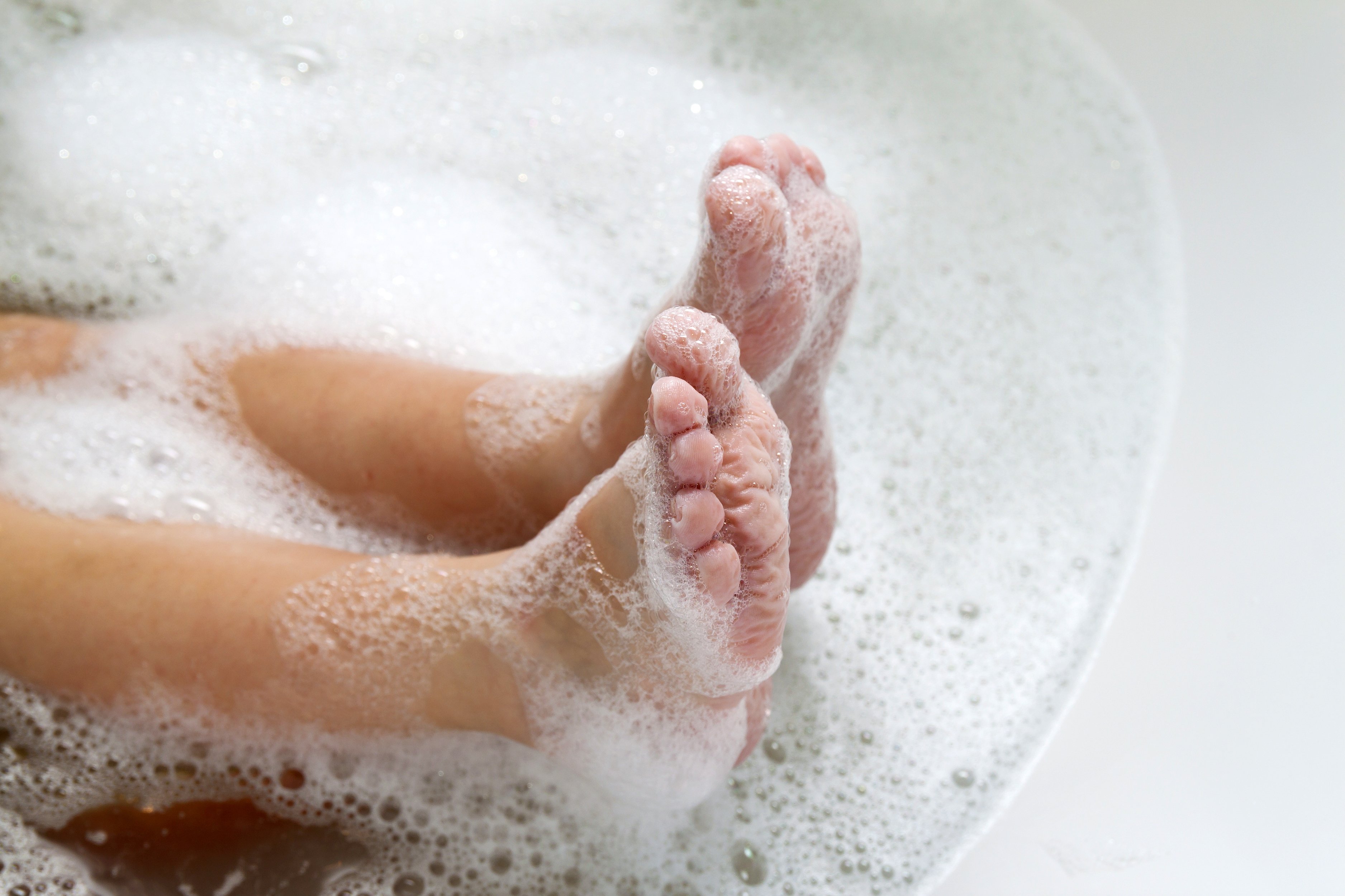 Feet soaked in warm soapy water | Photo: Shutterstock