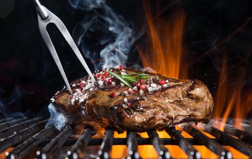 Close up of a steak being grilled. | Source: Shutterstock.