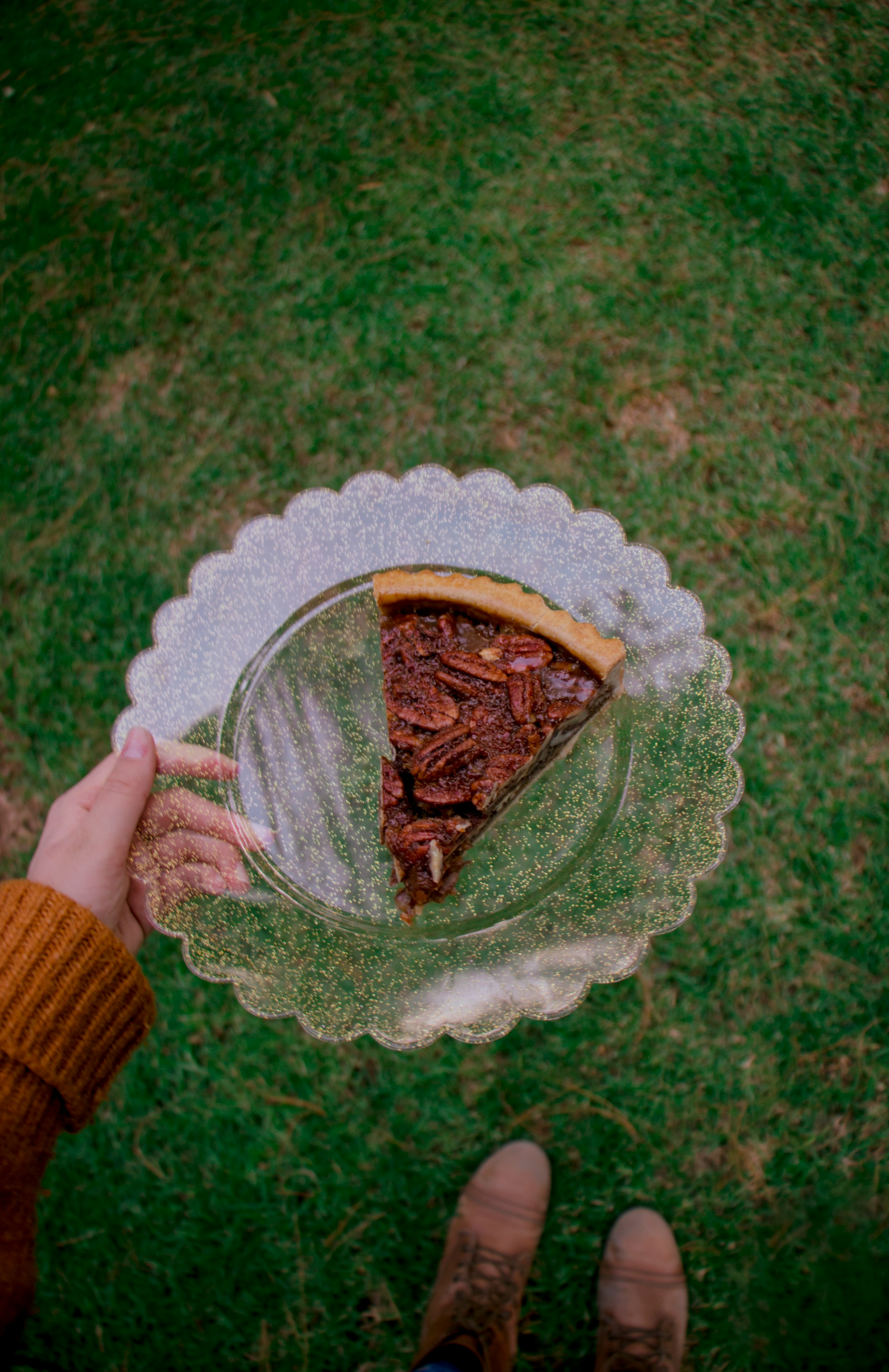 Woman holding a slice of pecan pie | Source: Unsplash