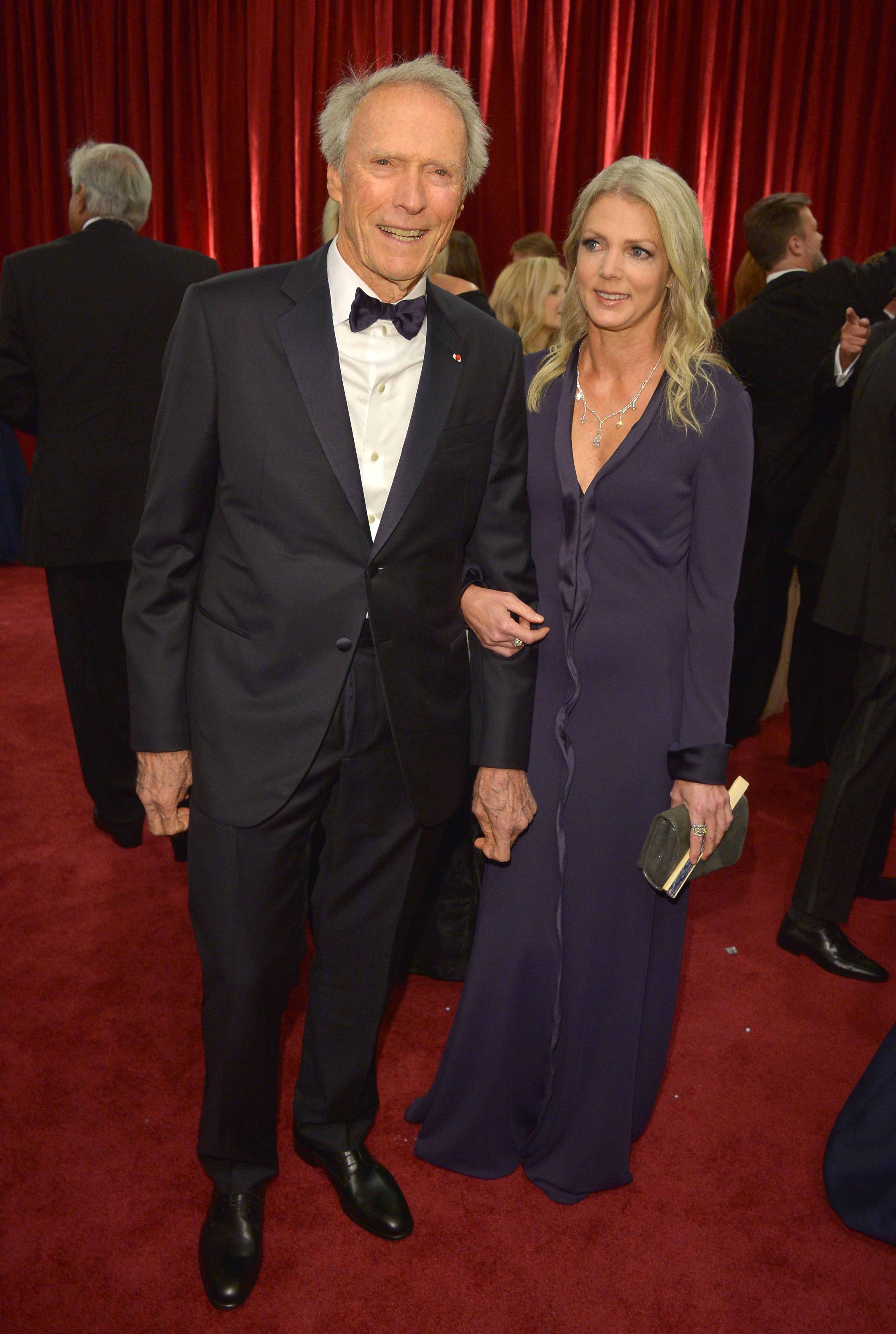 Clint Eastwood and Christina Sandera at the 87th Annual Academy Awards in Los Angeles, California on February 22, 2015 | Source: Getty Images