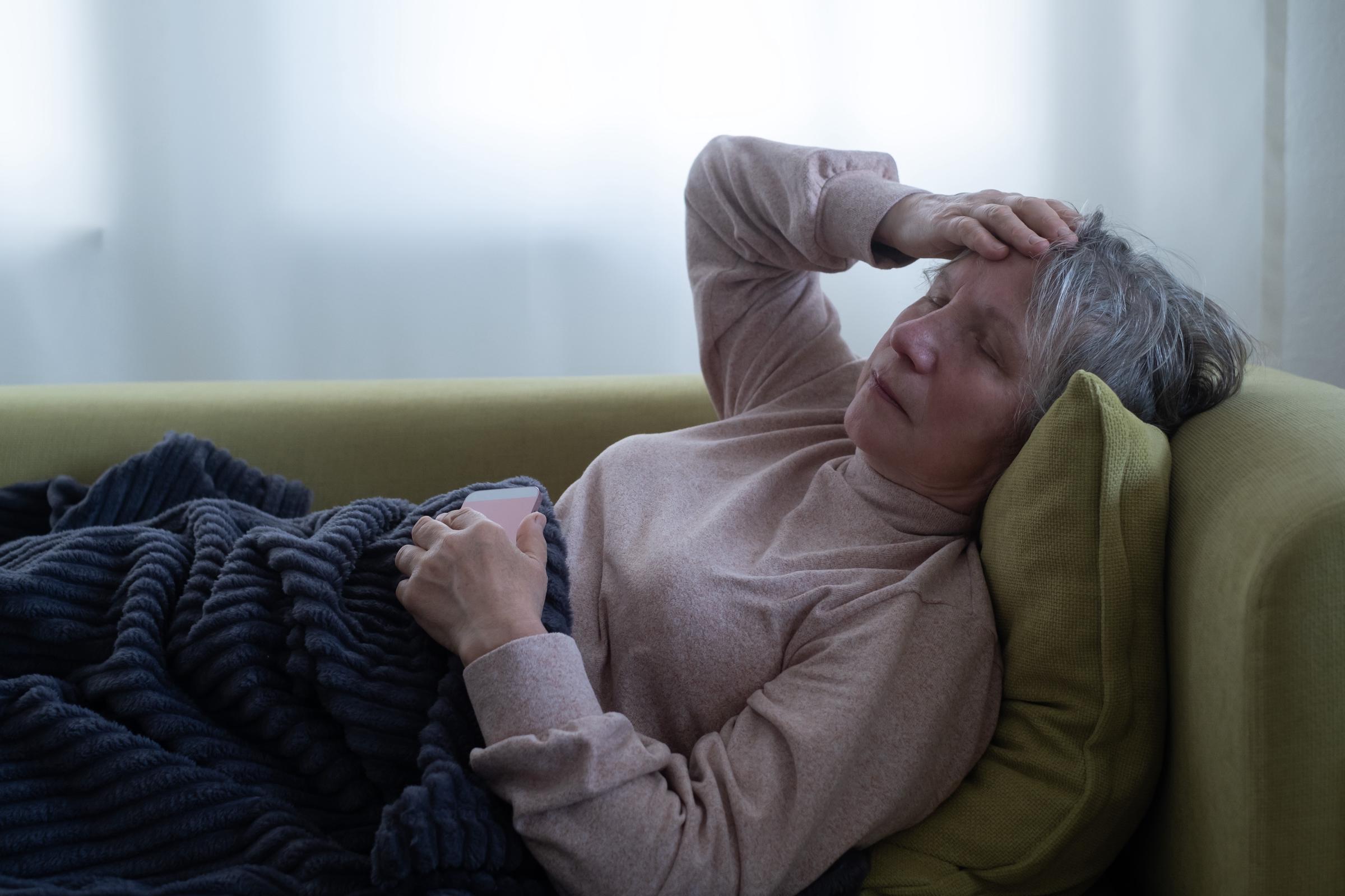 Tired woman resting on a couch | Source: Shutterstock