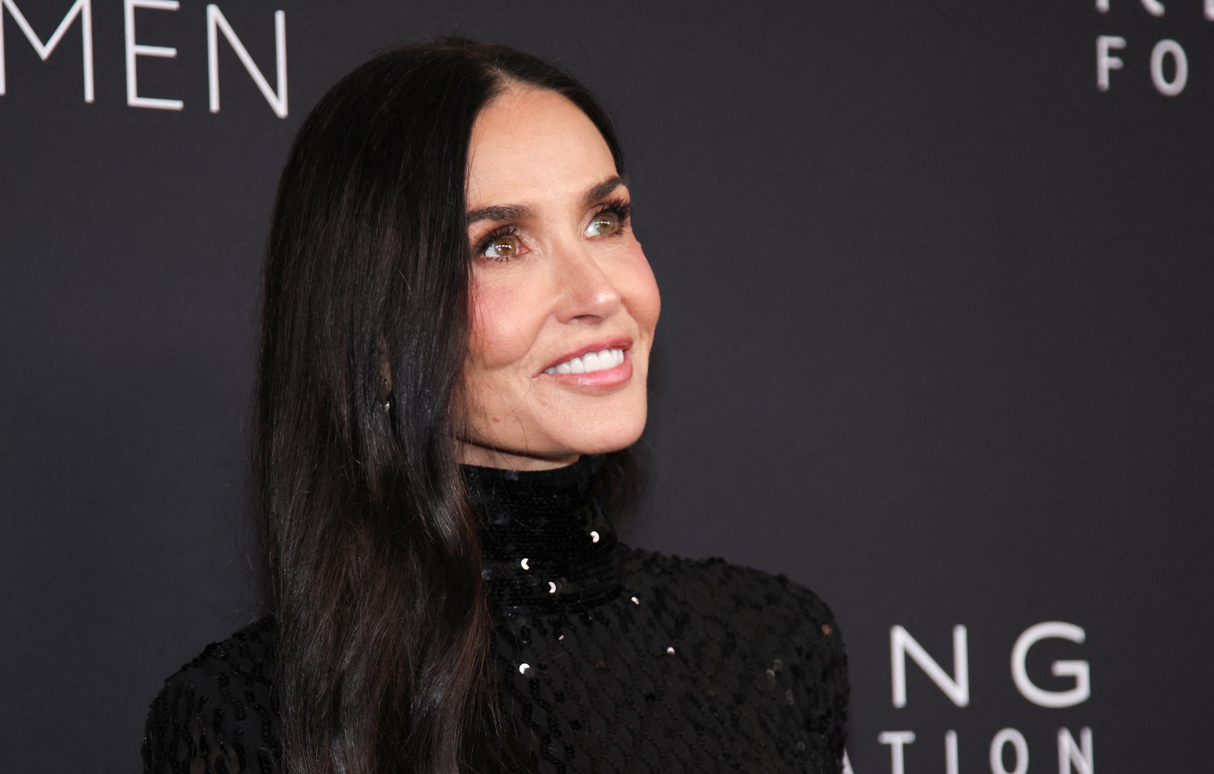 Demi Moore attends the Kering Foundation's 4th annual Caring for Women dinner at The Pool in New York on September 11, 2025. The actress wore her signature long, dark hair parted down the middle, styled sleek and straight, before bringing back her iconic bangs.