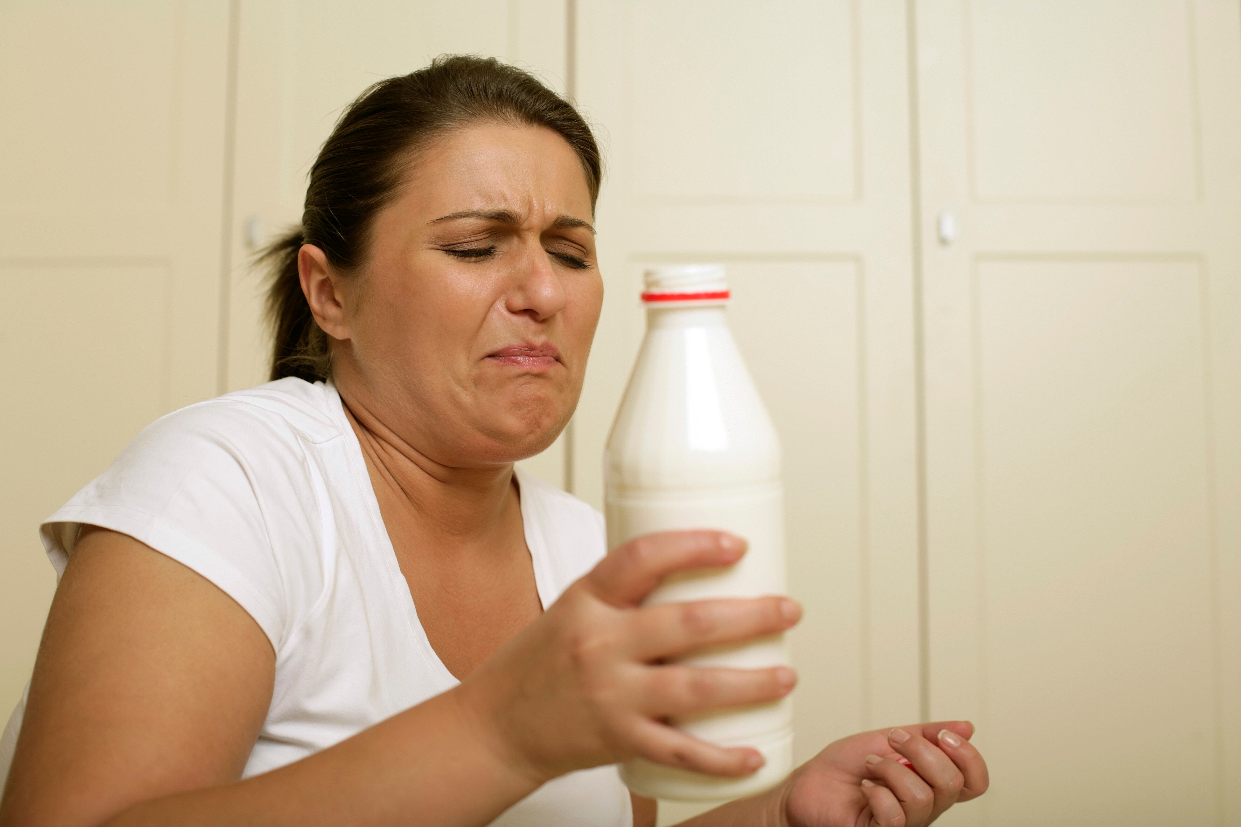 A woman rejecting the smell of milk | Source: Pexels