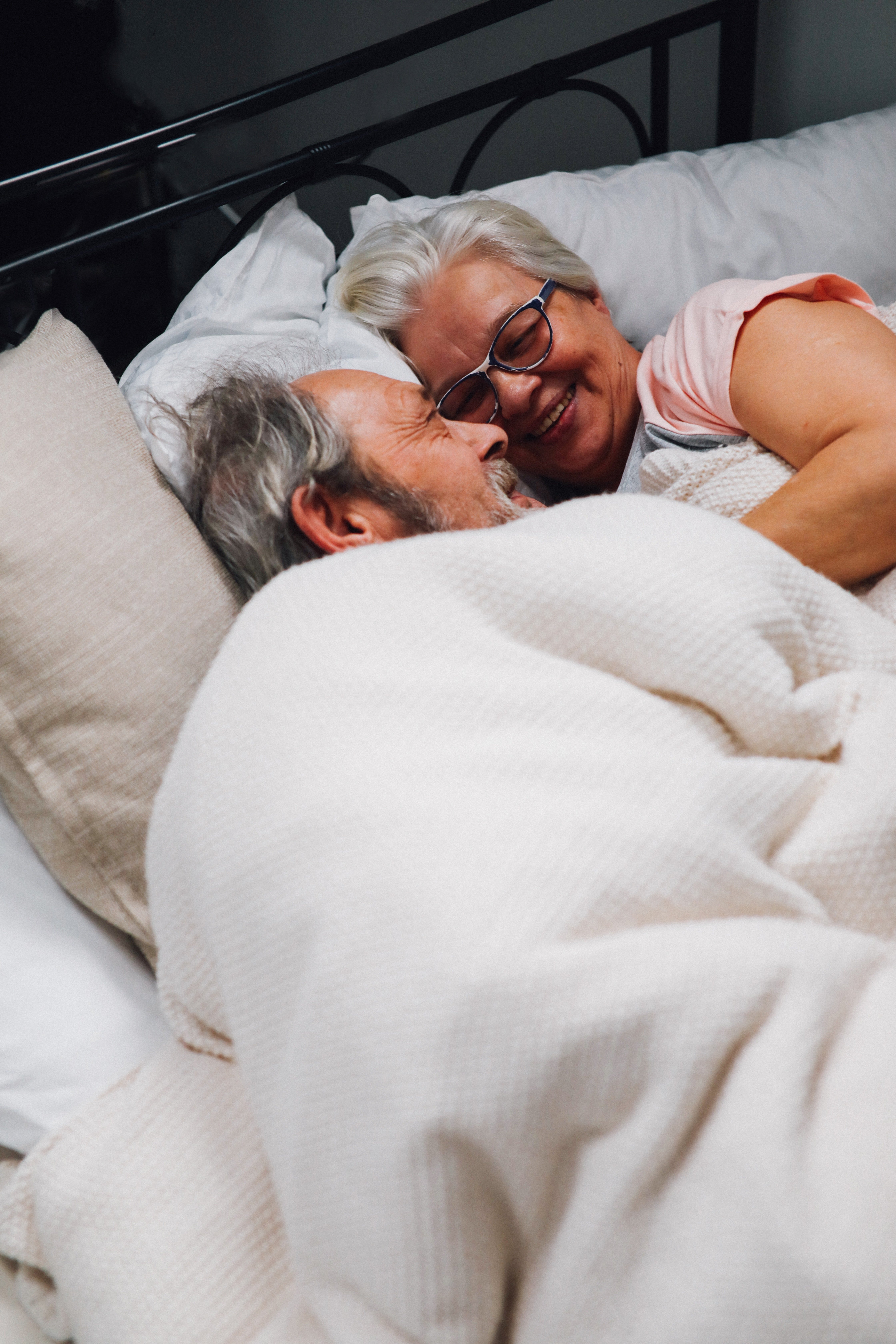 An elderly couple couddling in bed. Source: Pexels/ Tom Leishman
