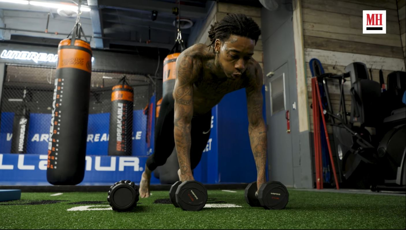 Wiz Khalifa works through a bodyweight-style strength exercise during an MMA-style workout featured in a video published on May 23, 2022. | Source: YouTube/Men's Health