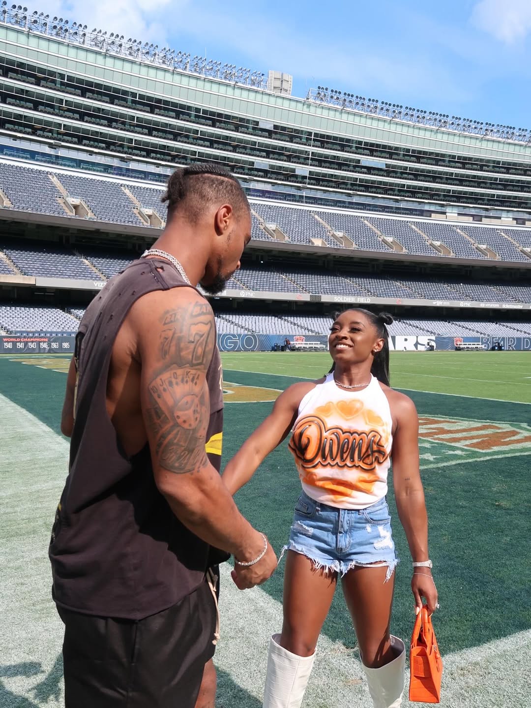 Simone Biles and Jonathan Owens standing in Soldier Field, from her post dated August 12, 2025 | Source: Instagram/simonebiles