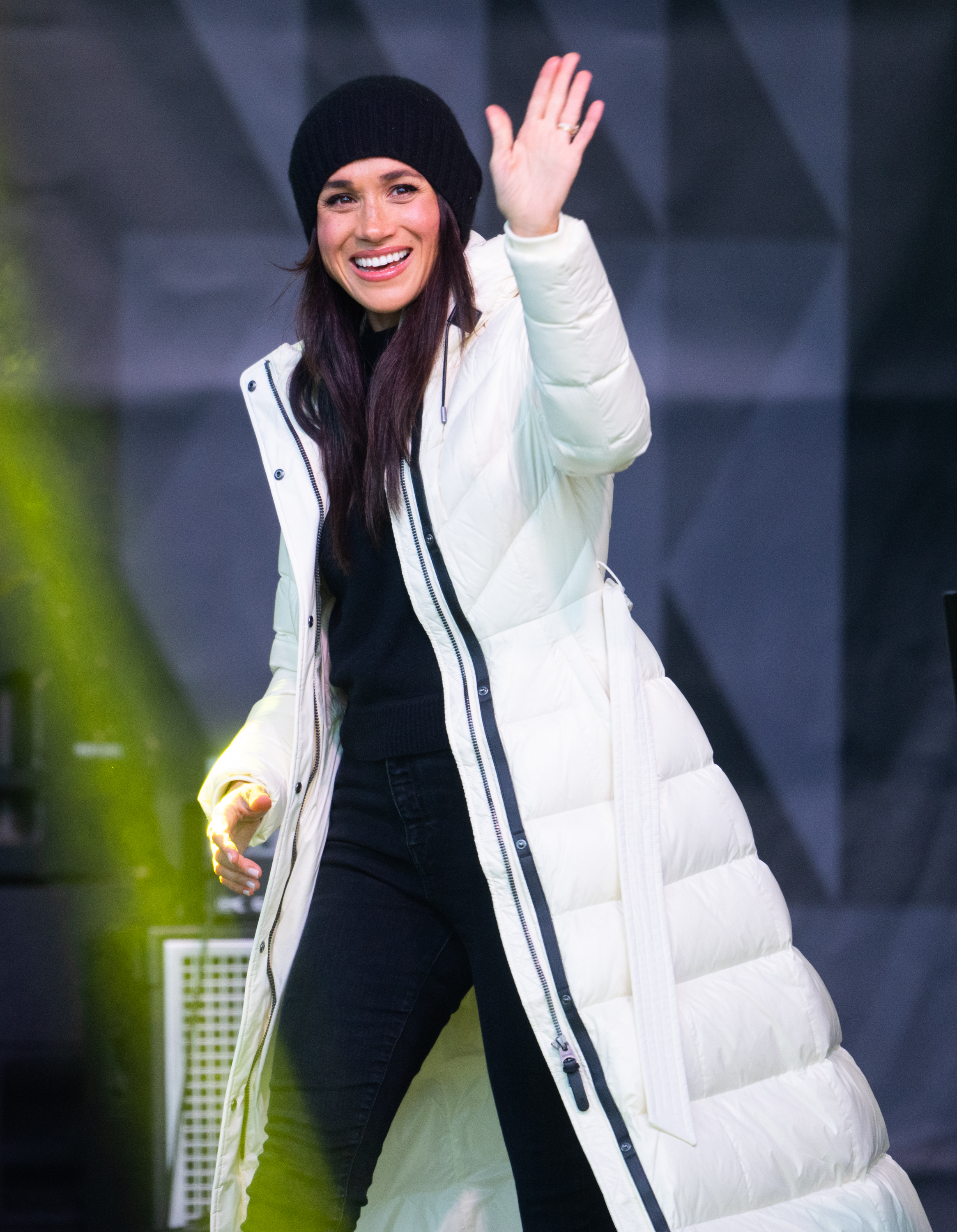 Meghan Markle smiling and waving at cameras. | Source: Getty Images