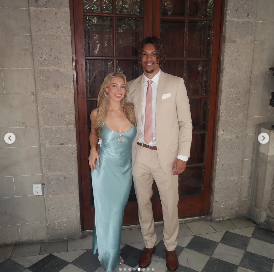 Brandon Clarke poses with his sister, wearing a cream-colored suit and pink tie while she stuns in a satin blue gown. | Source: Instagram/brandon_clarke23