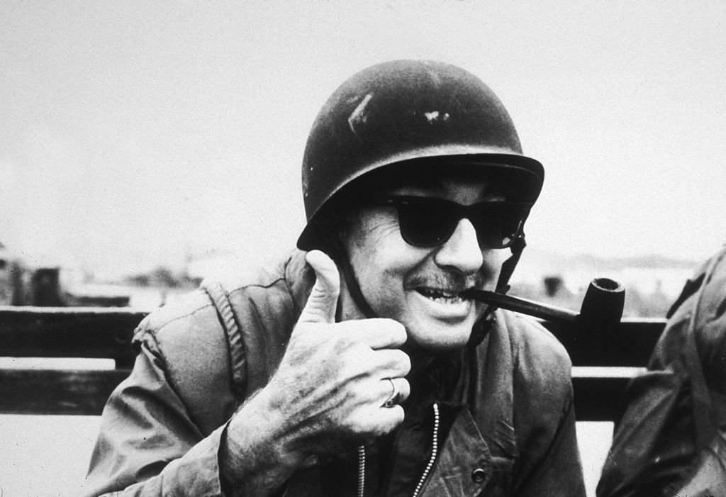 American broadcast journalist Walter Cronkite gives a thumbs up with his pipe clenched between his teeth while reporting for CBS in Vietnam. | Source: Getty Images