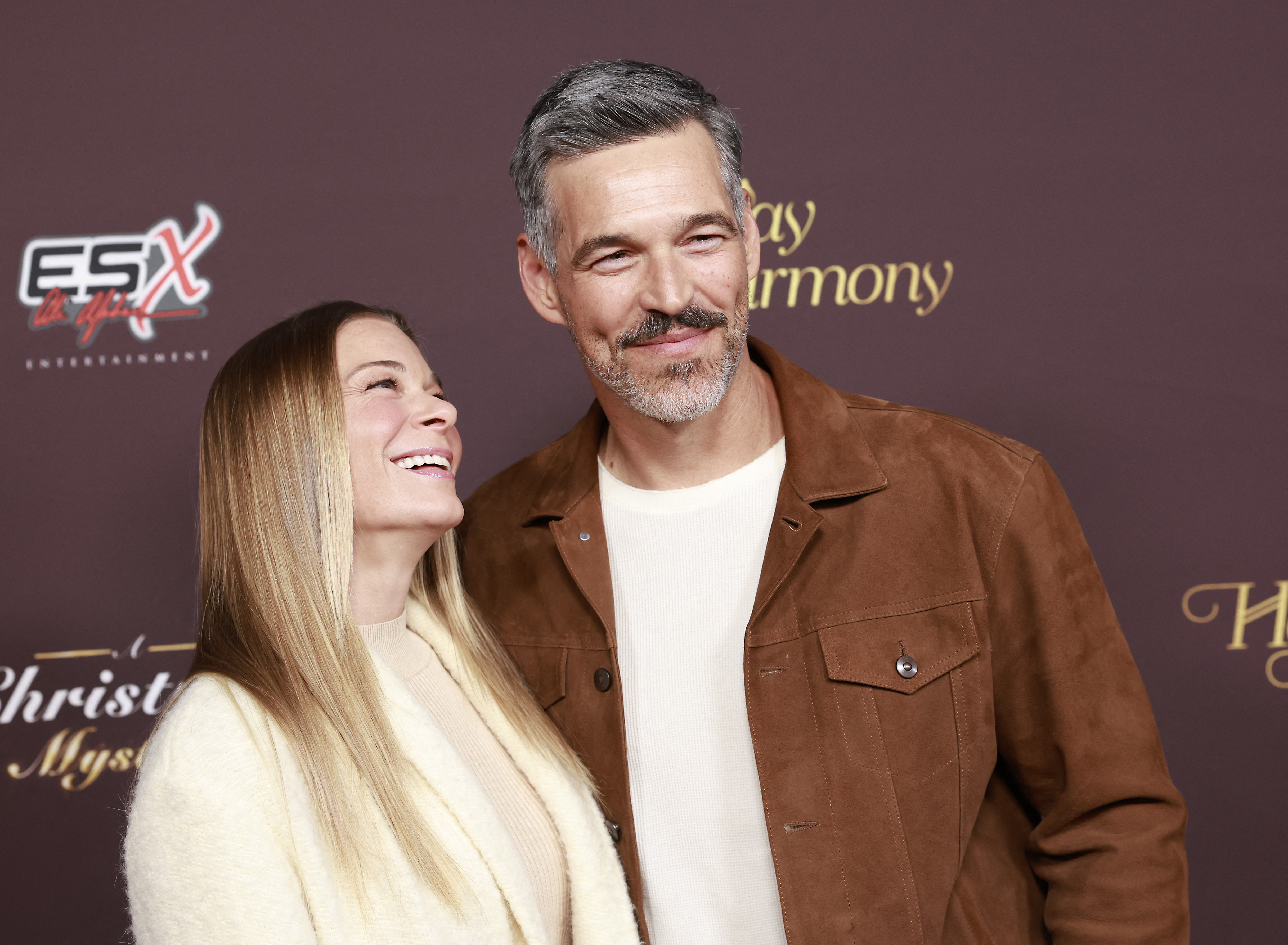 LeAnn Rimes (L) and husband Eddie Cibrian attend Warner Bros. and HBO Max Holiday Movies event at the Warner Bros. studio lot in, Burbank, California, on November 16, 2022. | Source: Getty Images