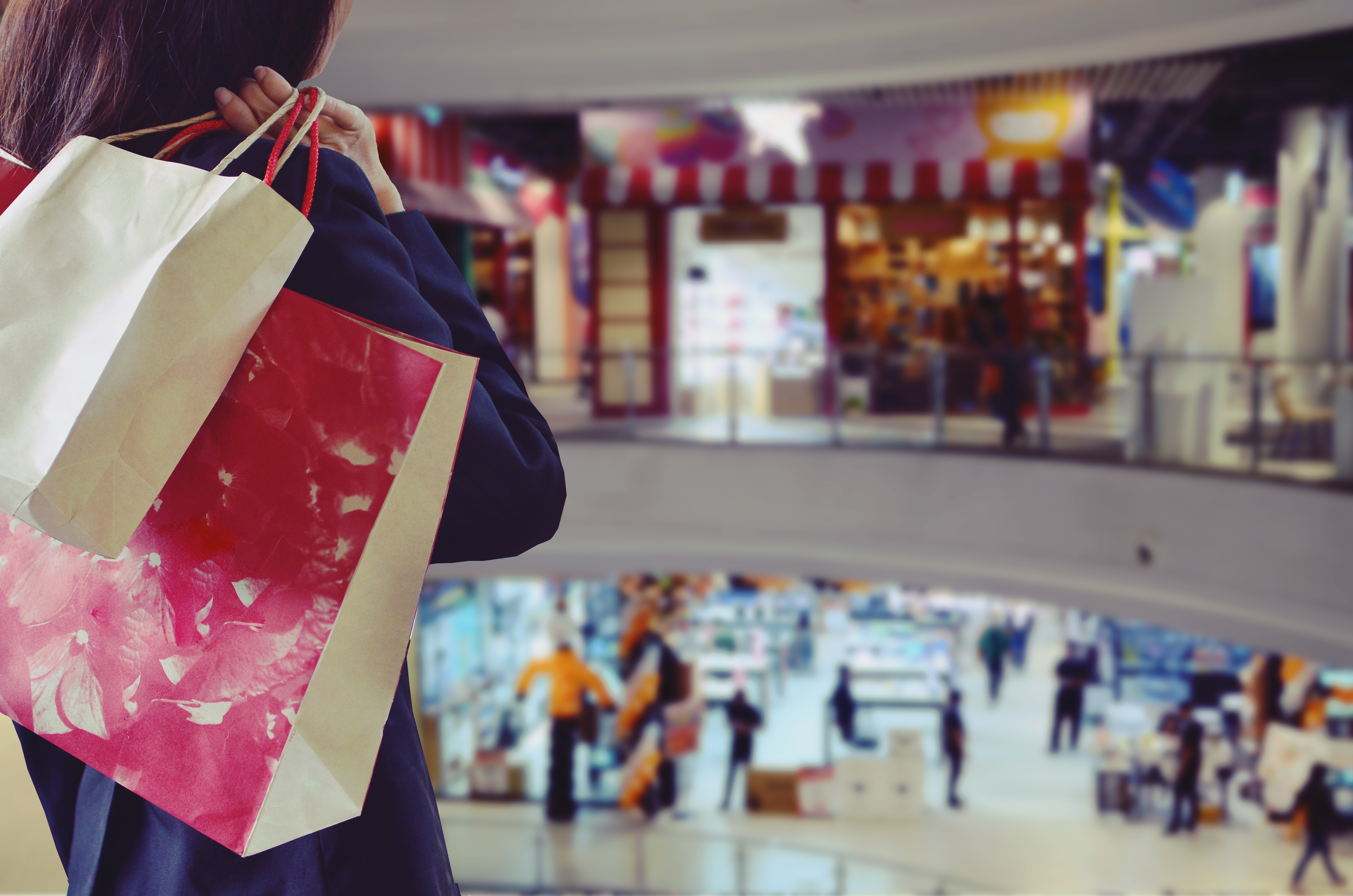 A woman holding shopping bags | Source: Shutterstock