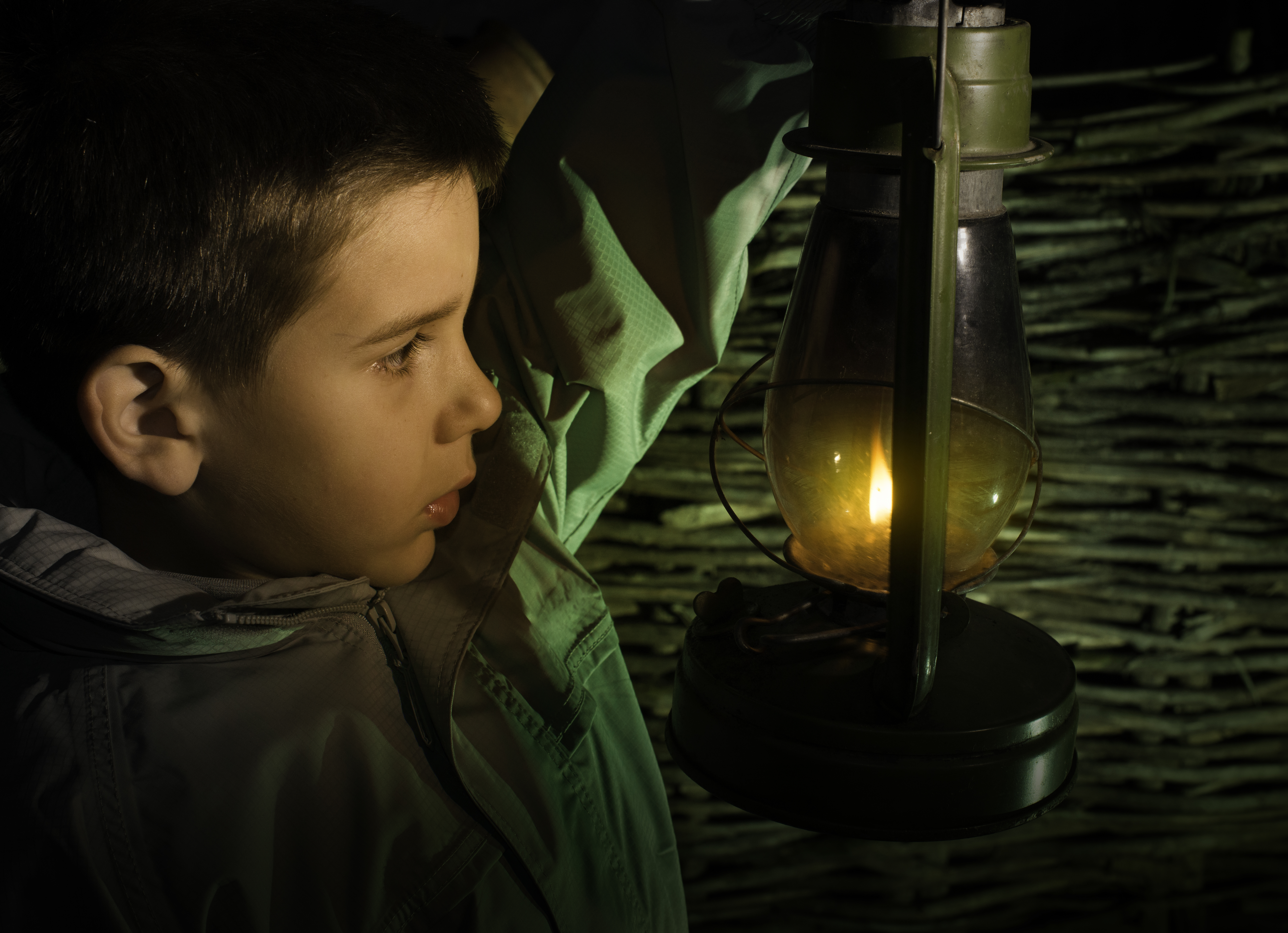 Child walk in the darkness with gas lantern | Source: Shutterstock.com