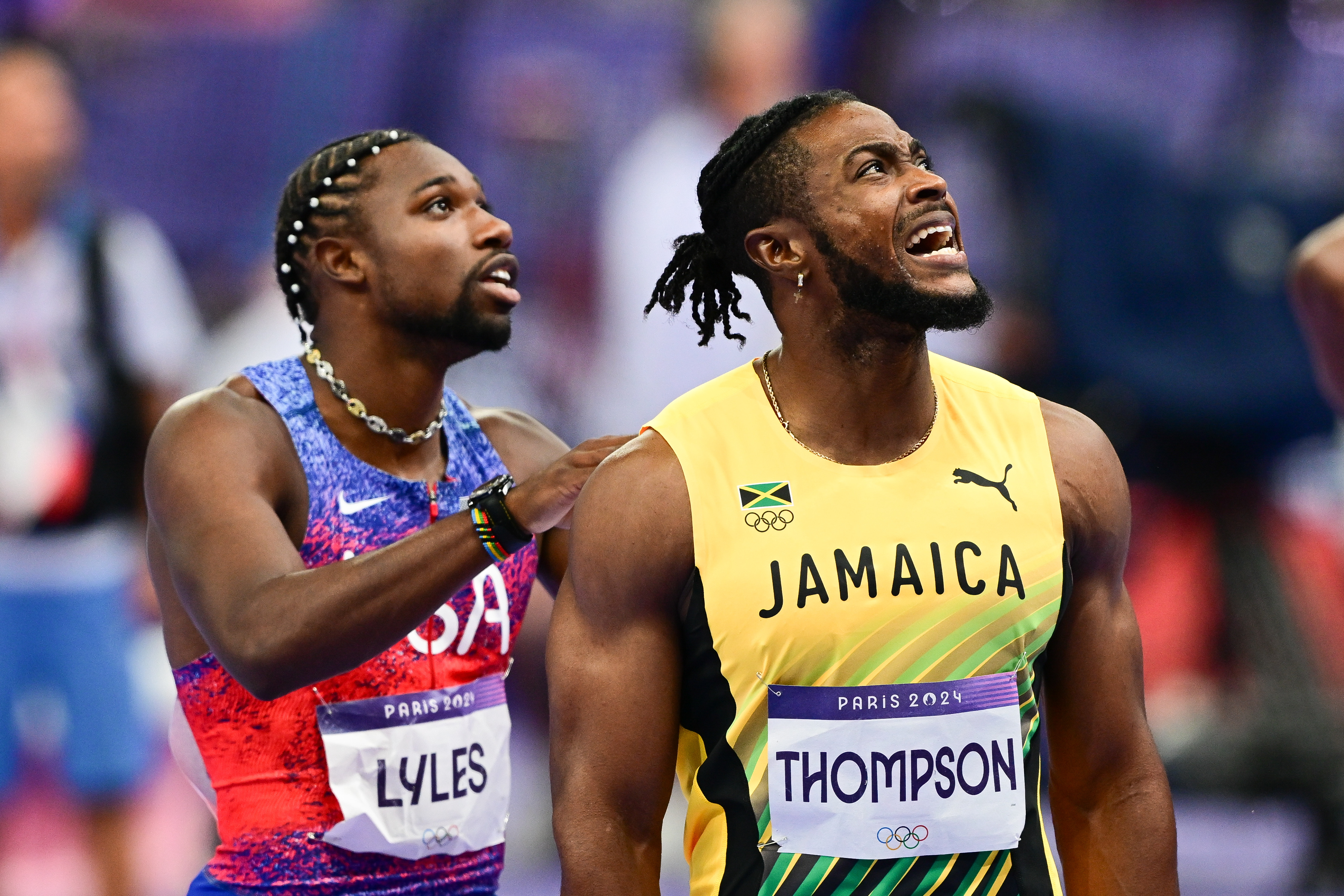 Noah Lyles and Kishane Thompson wait for the results of the competition during the men's 100m final of the athletics event at the Paris 2024 Olympic Games in Saint-Denis, Paris, on August 4, 2024. | Source: Getty Images