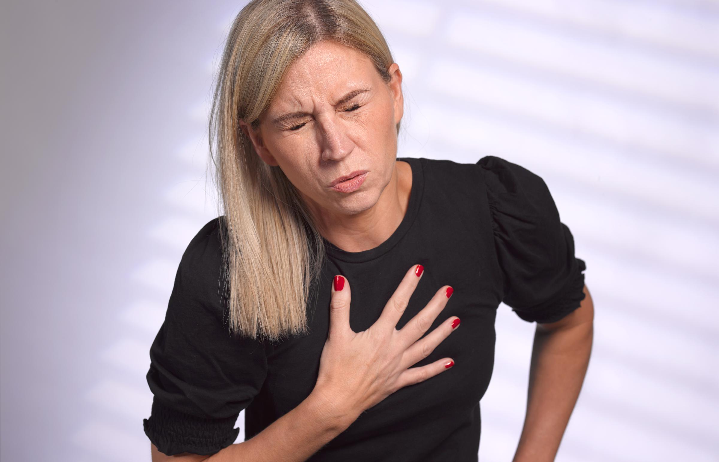 Woman clutches her chest in pain | Source: Getty Images